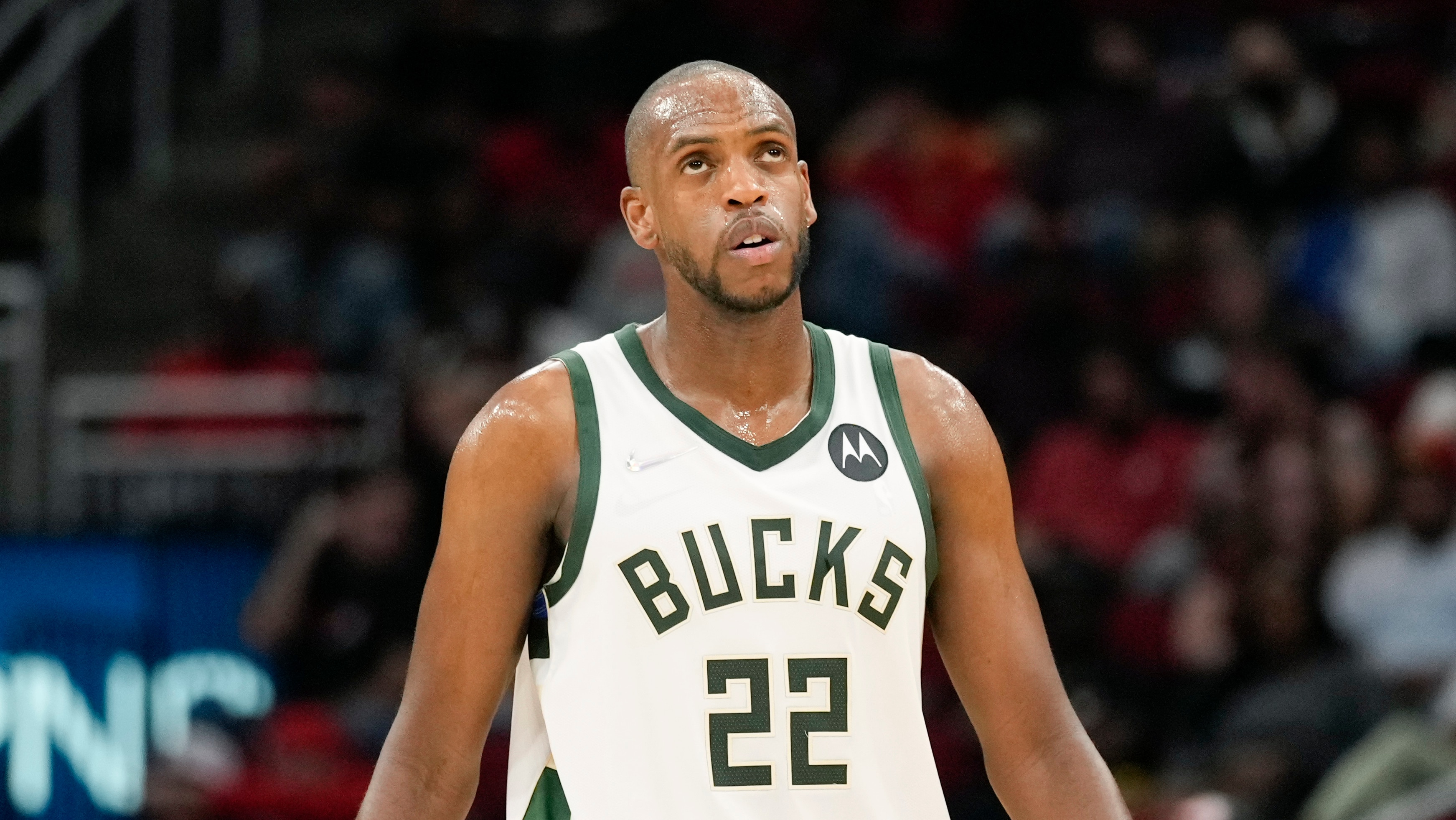 Milwaukee Bucks forward Khris Middleton looks at the scoreboard during the first half of an NBA basketball game against the Houston Rockets, Friday, Dec. 10, 2021, in Houston. (AP Photo/Eric Christian Smith)