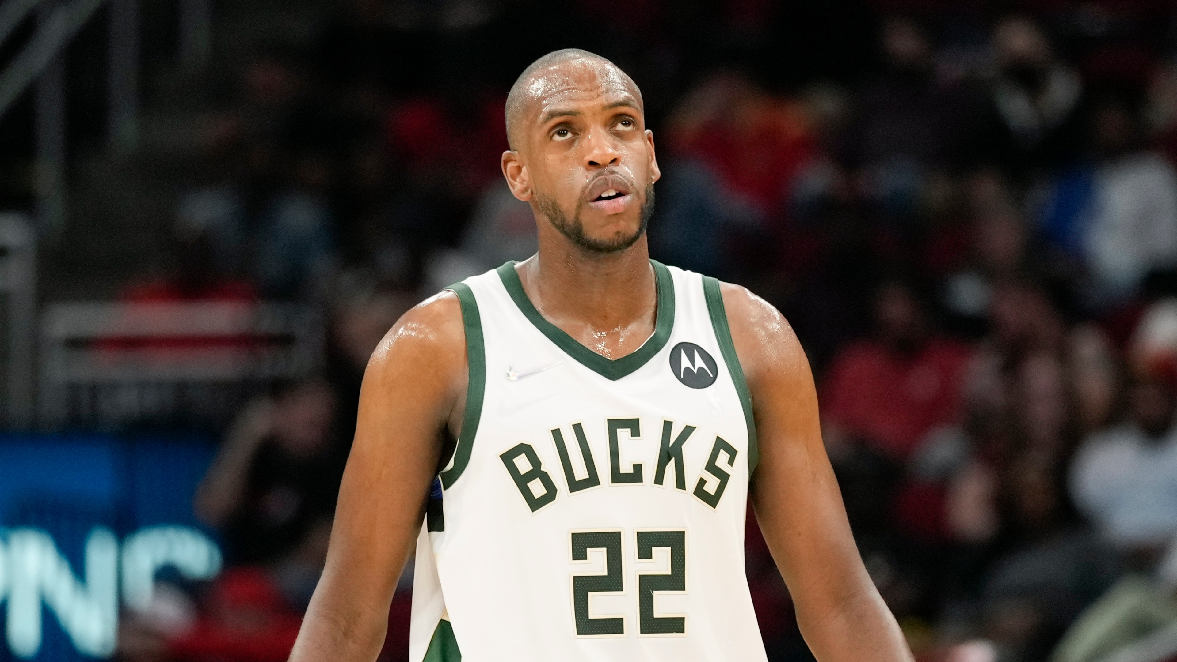 Milwaukee Bucks forward Khris Middleton looks at the scoreboard during the first half of an NBA basketball game against the Houston Rockets, Friday, Dec. 10, 2021, in Houston. (AP Photo/Eric Christian Smith)