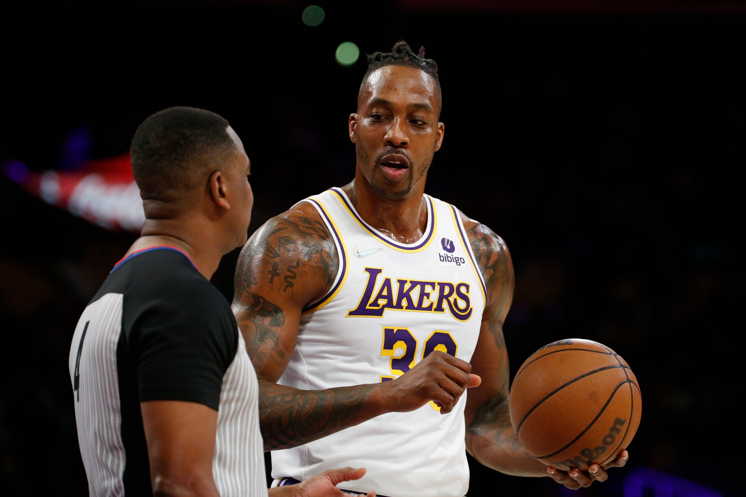 Los Angeles Lakers center Dwight Howard (39) confers with a referee during the first half of an NBA basketball game in Los Angeles, Sunday, Dec. 12, 2021. (AP Photo/Ringo H.W. Chiu) Los Angeles Lakers center Dwight Howard (39) confers with a referee during the first half of an NBA basketball game in Los Angeles, Sunday, Dec. 12, 2021. (AP Photo/Ringo H.W. Chiu)