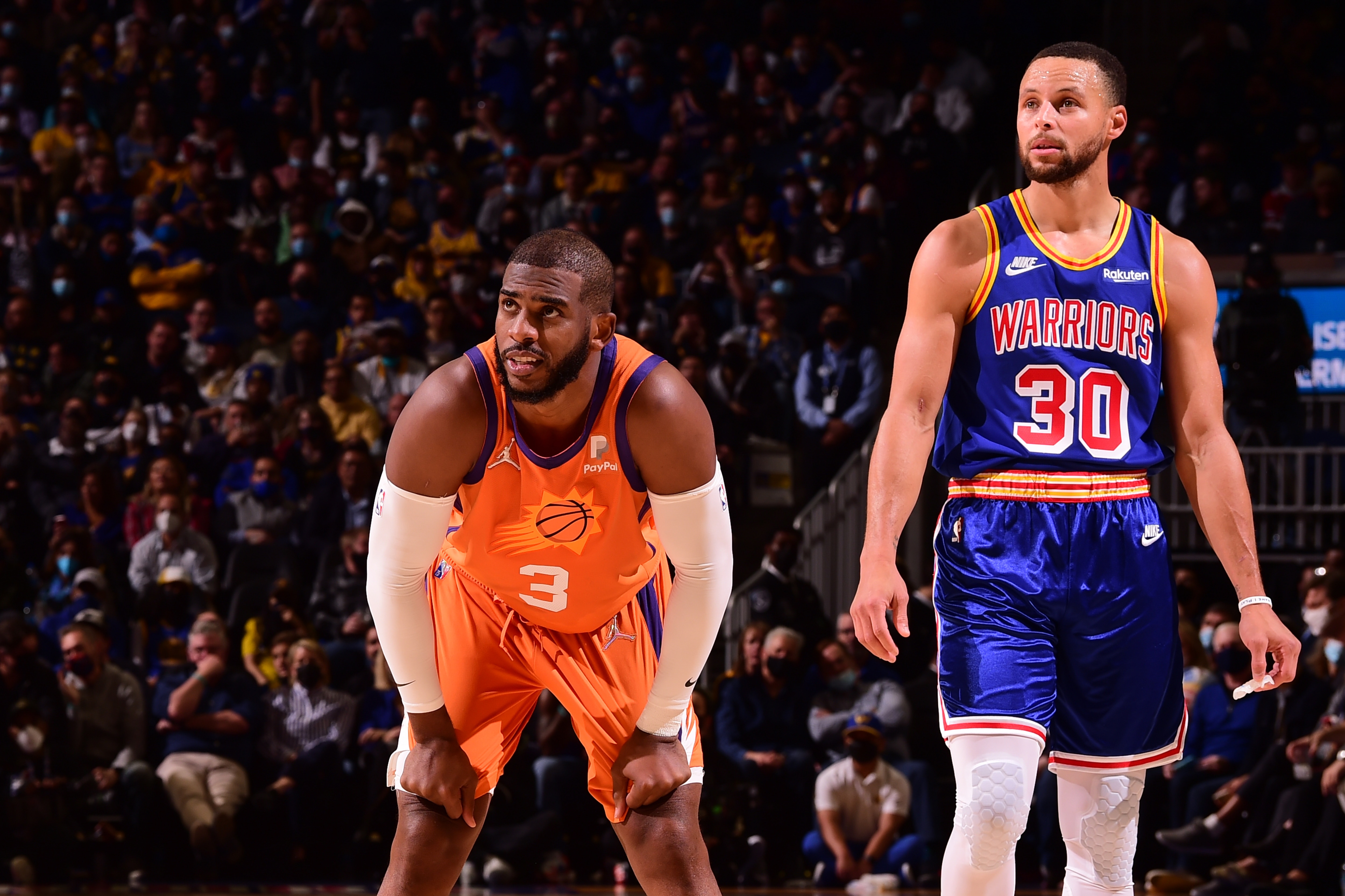 SAN FRANCISCO, CA - DECEMBER 3: Chris Paul #3 of the Phoenix Suns and Stephen Curry #30 of the Golden State Warriors looks on during the game on December, 2021 at Chase Center in San Francisco, California. NOTE TO USER: User expressly acknowledges and agrees that, by downloading and or using this photograph, user is consenting to the terms and conditions of Getty Images License Agreement. Mandatory Copyright Notice: Copyright 2021 NBAE (Photo by Noah Graham/NBAE via Getty Images)