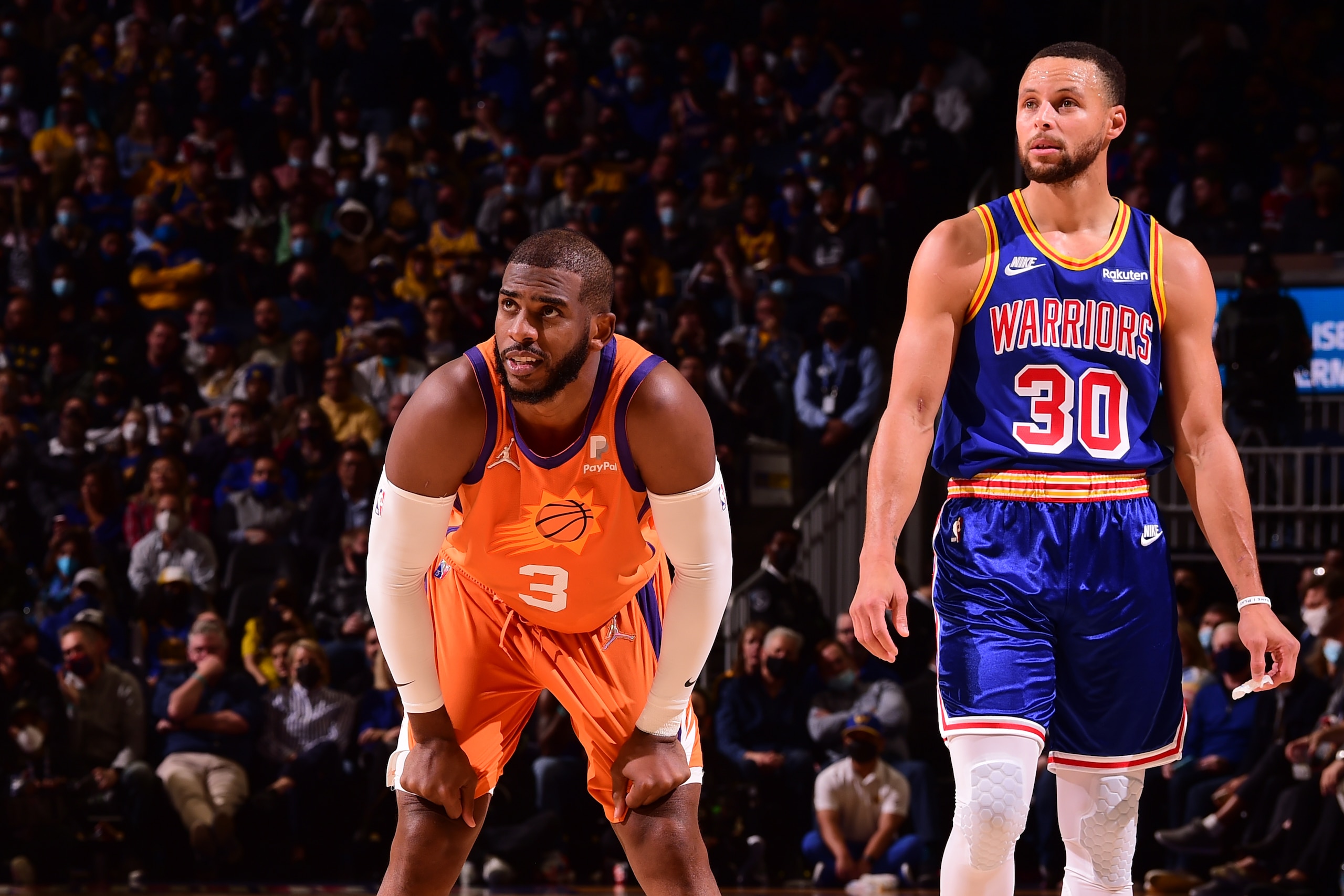 SAN FRANCISCO, CA - DECEMBER 3: Chris Paul #3 of the Phoenix Suns and Stephen Curry #30 of the Golden State Warriors looks on during the game on December, 2021 at Chase Center in San Francisco, California. NOTE TO USER: User expressly acknowledges and agrees that, by downloading and or using this photograph, user is consenting to the terms and conditions of Getty Images License Agreement. Mandatory Copyright Notice: Copyright 2021 NBAE (Photo by Noah Graham/NBAE via Getty Images)