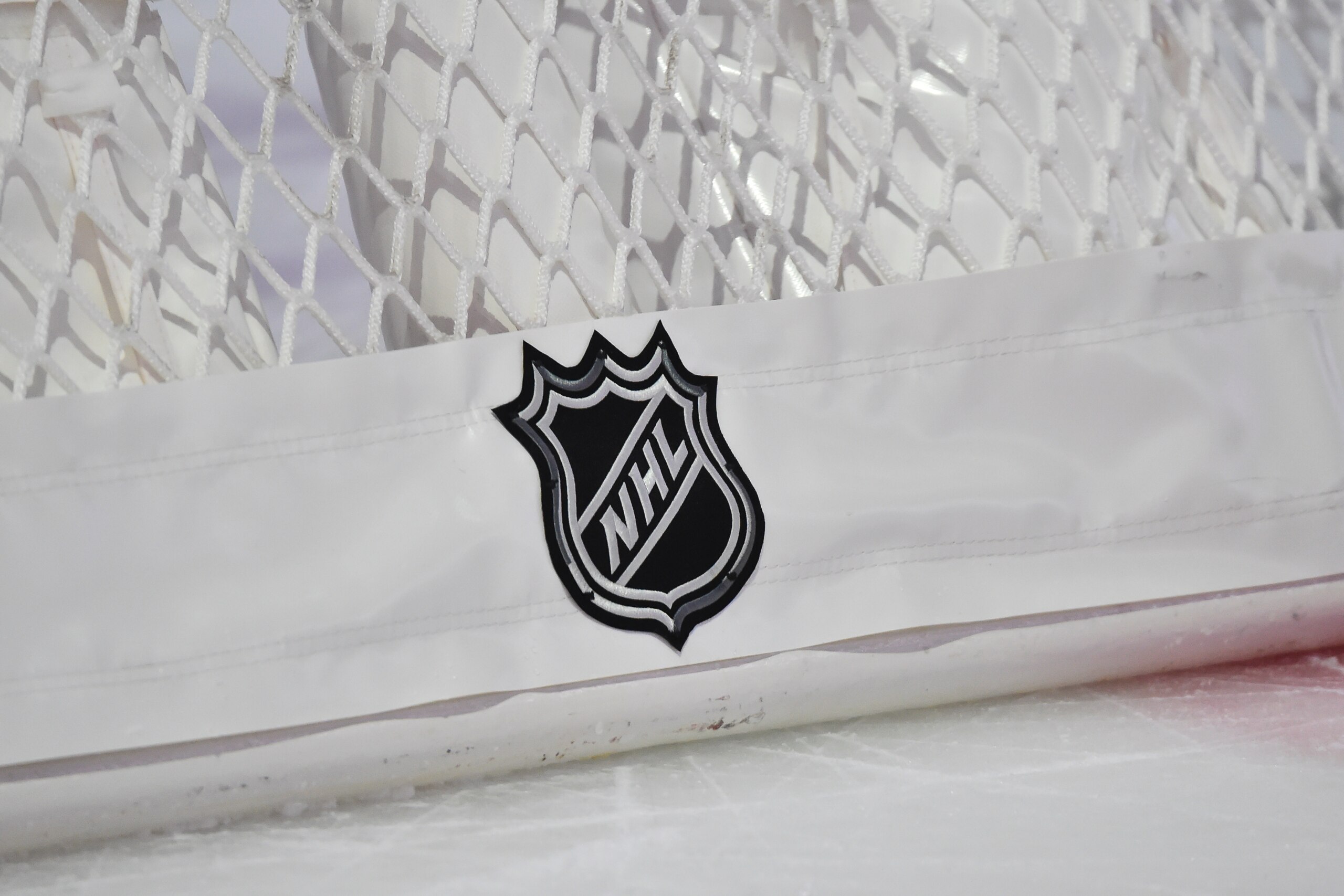 MONTREAL, QC - JANUARY 30:  The NHL logo displayed behind a hockey net during intermission between the Montreal Canadiens and the Calgary Flames at the Bell Centre on January 30, 2021 in Montreal, Canada.  The Calgary Flames defeated the Montreal Canadiens 2-0.  (Photo by Minas Panagiotakis/Getty Images)