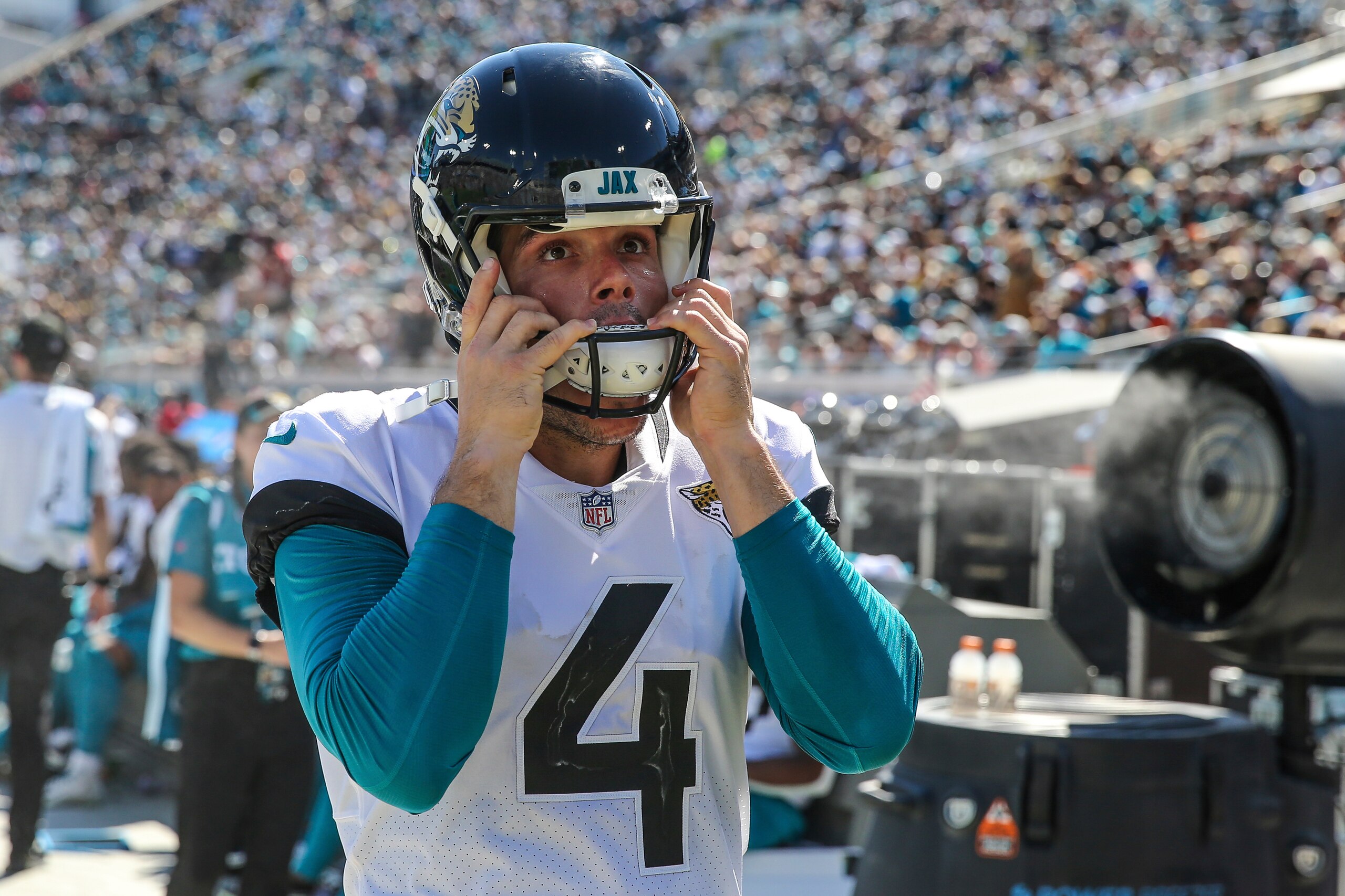 Jacksonville Jaguars place kicker Josh Lambo (4) looks up at the video screen while putting hus helmet on during the second half of an NFL football game against the Arizona Cardinals, Sunday, Sept. 26, 2021, in Jacksonville, Fla. The Cardinals defeated the Jaguars 31-19. (AP Photo/Gary McCullough)