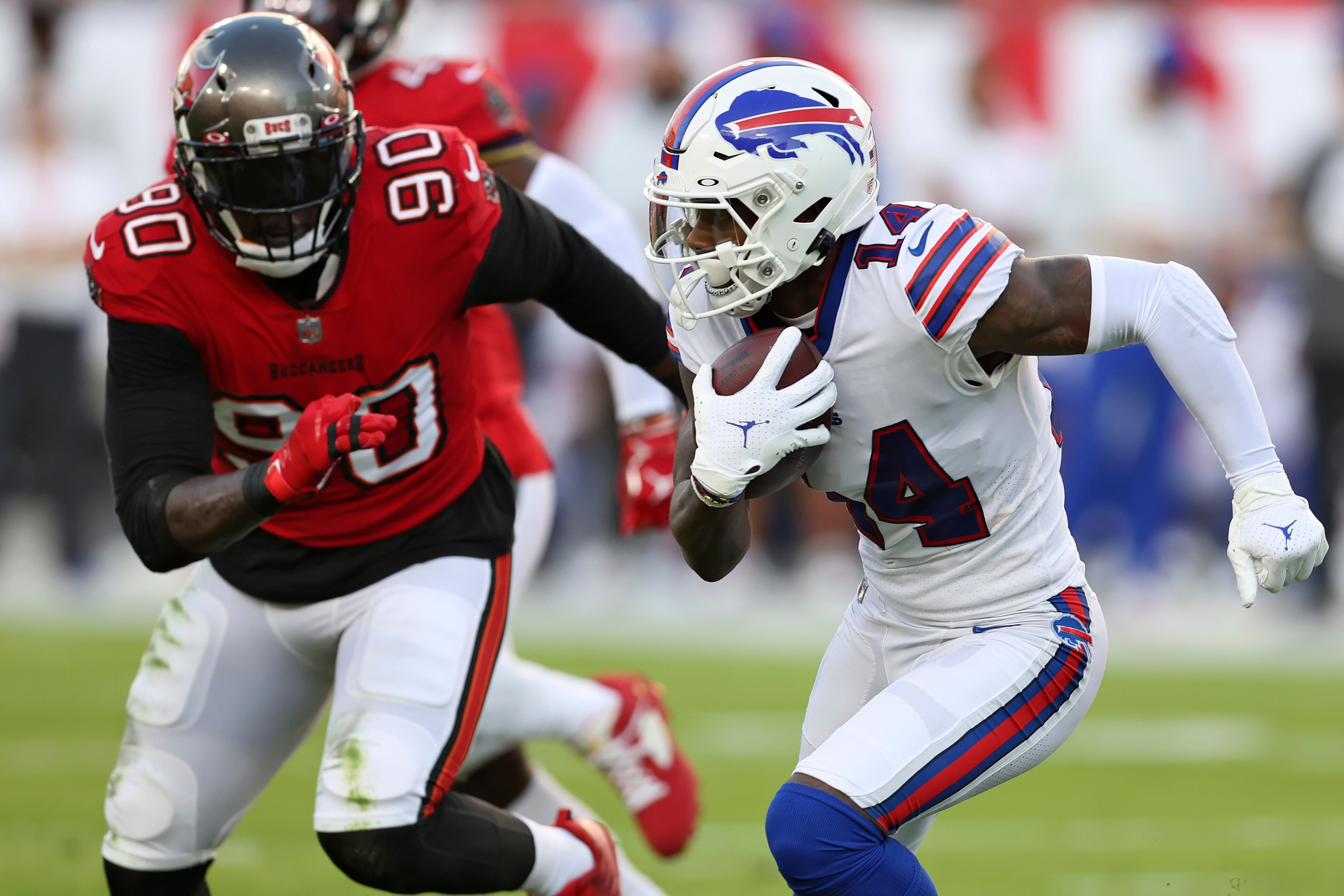 Buffalo Bills wide receiver Stefon Diggs (14) runs away from Tampa Bay Buccaneers linebacker Jason Pierre-Paul (90) after a catch during the first half of an NFL football game Sunday, Dec. 12, 2021, in Tampa, Fla. (AP Photo/Mark LoMoglio)