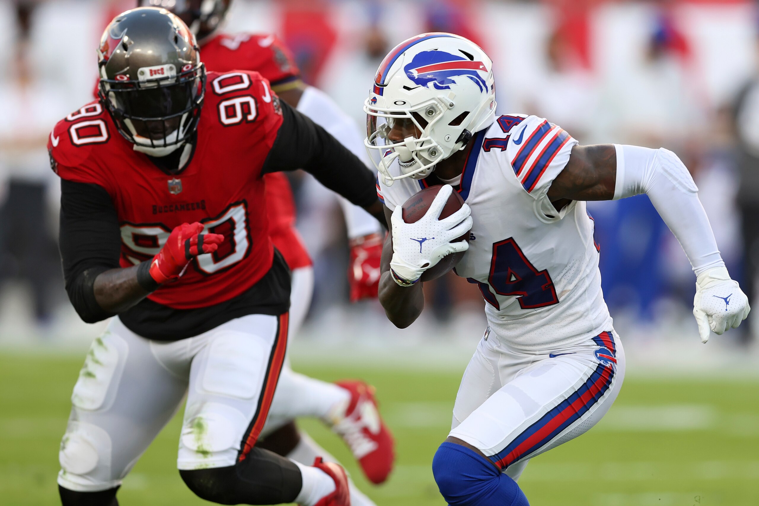 Buffalo Bills wide receiver Stefon Diggs (14) runs away from Tampa Bay Buccaneers linebacker Jason Pierre-Paul (90) after a catch during the first half of an NFL football game Sunday, Dec. 12, 2021, in Tampa, Fla. (AP Photo/Mark LoMoglio)