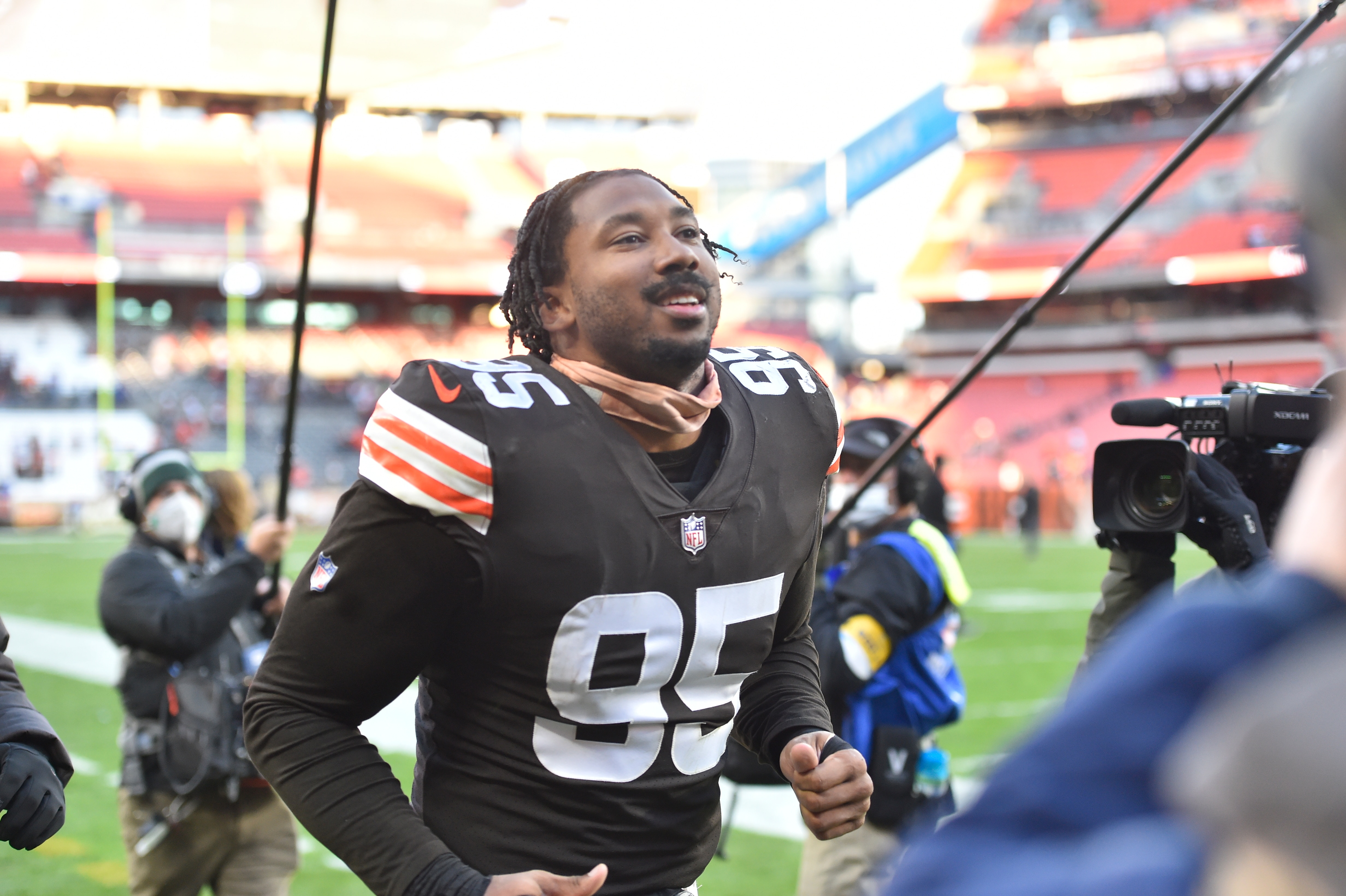 Cleveland Browns defensive end Myles Garrett (95) plays catch with fans in the stands before an NFL football game against the Baltimore Ravens, Sunday, Dec. 12, 2021, in Cleveland. The Browns won 24-22. (AP Photo/David Richard)