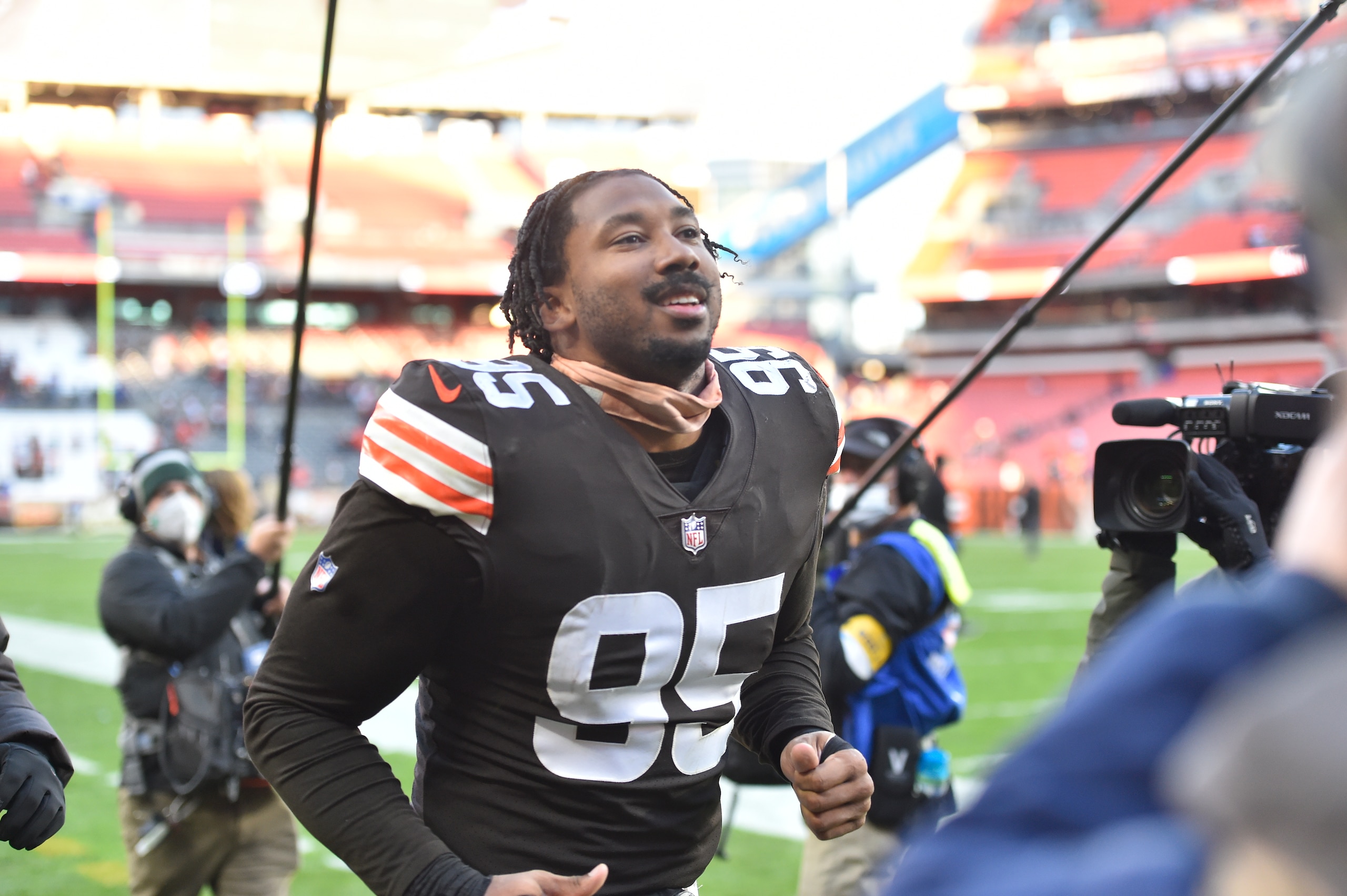 Cleveland Browns defensive end Myles Garrett (95) plays catch with fans in the stands before an NFL football game against the Baltimore Ravens, Sunday, Dec. 12, 2021, in Cleveland. The Browns won 24-22. (AP Photo/David Richard)