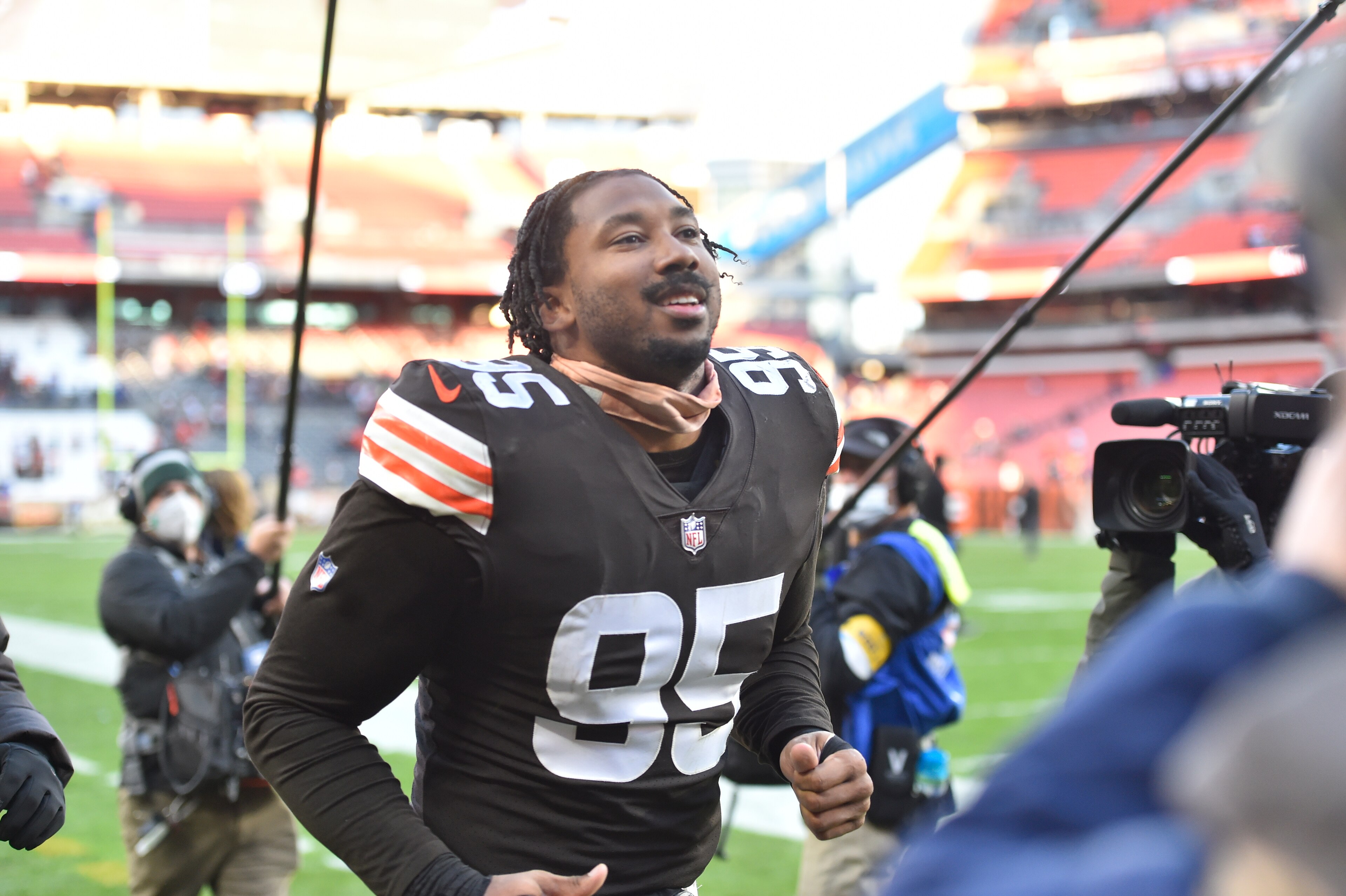 Cleveland Browns defensive end Myles Garrett (95) plays catch with fans in the stands before an NFL football game against the Baltimore Ravens, Sunday, Dec. 12, 2021, in Cleveland. The Browns won 24-22. (AP Photo/David Richard)