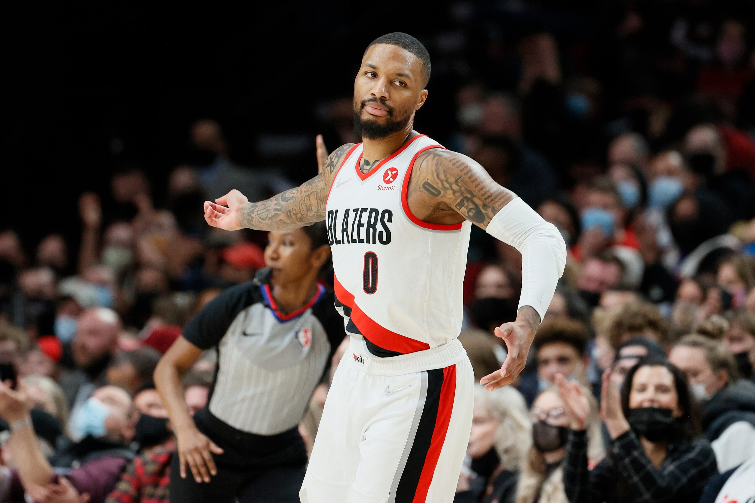 PORTLAND, OREGON - DECEMBER 15: Damian Lillard #0 of the Portland Trail Blazers reacts after his three point basket against the Memphis Grizzlies during the second quarter at Moda Center on December 15, 2021 in Portland, Oregon. NOTE TO USER: User expressly acknowledges and agrees that, by downloading and or using this photograph, User is consenting to the terms and conditions of the Getty Images License Agreement. (Photo by Steph Chambers/Getty Images)