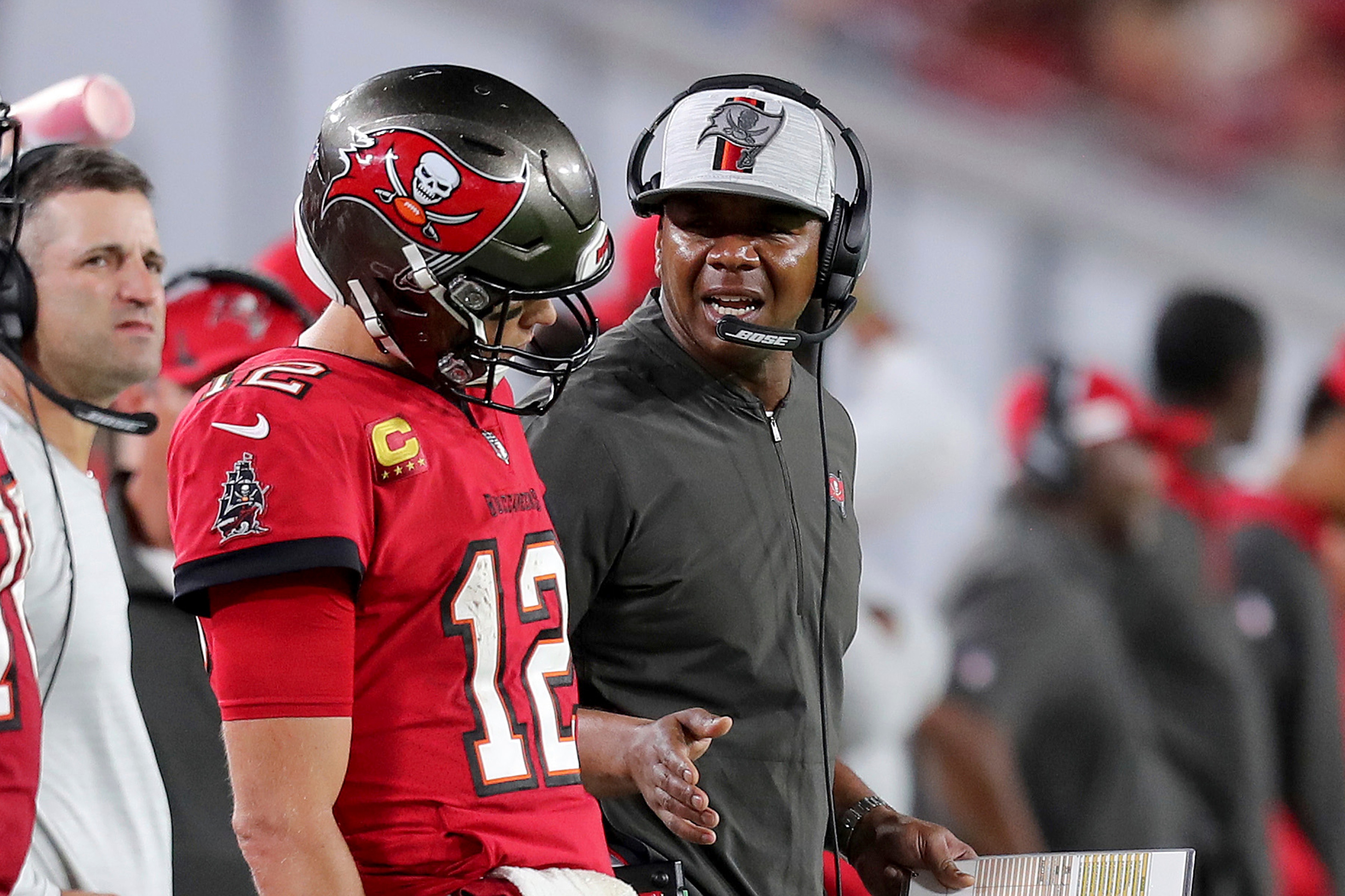 Byron Leftwich, Offensive Coordinator for the Tampa Bay Buccaneers speaks with Tampa Bay Buccaneers quarterback Tom Brady (12) during a NFL football game against the Buffalo Bills, Sunday, Dec.12, 2021 in Tampa, Fla. (AP Photo/Alex Menendez)