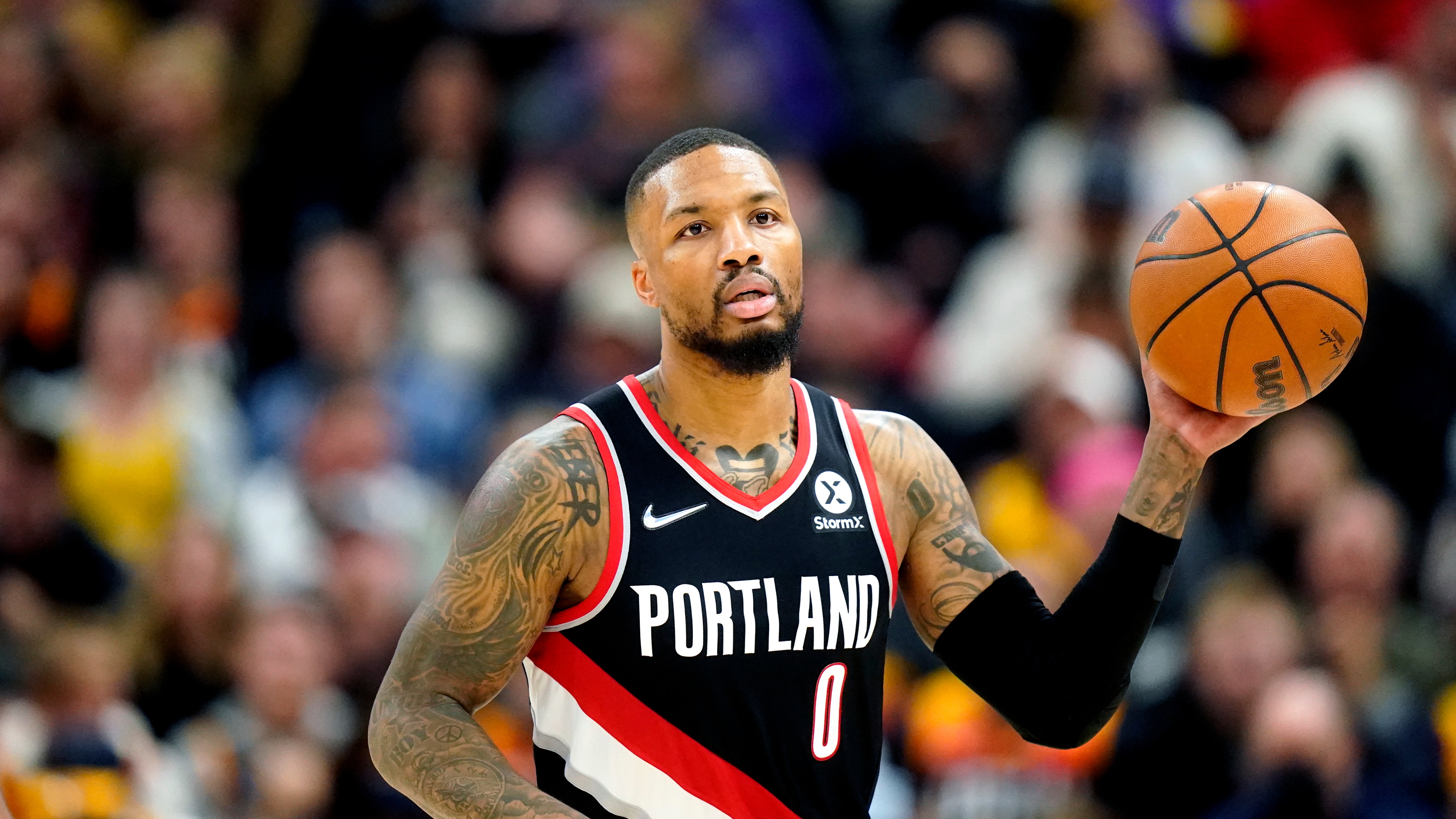 Portland Trail Blazers guard Damian Lillard (0) brings the ball up court in the first half during an NBA basketball game against the Utah Jazz Monday, Nov. 29, 2021, in Salt Lake City. (AP Photo/Rick Bowmer)