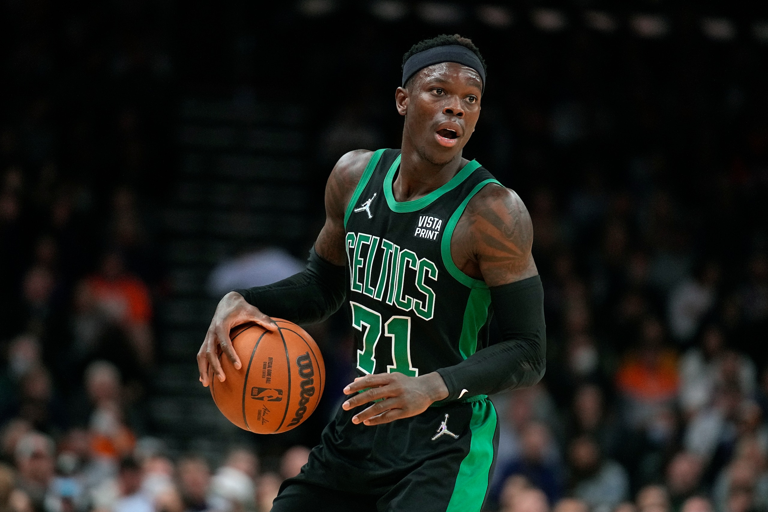 Boston Celtics guard Dennis Schroder (71) during the first half of an NBA basketball game against the Phoenix Suns, Friday, Dec. 10, 2021, in Phoenix. (AP Photo/Rick Scuteri)
