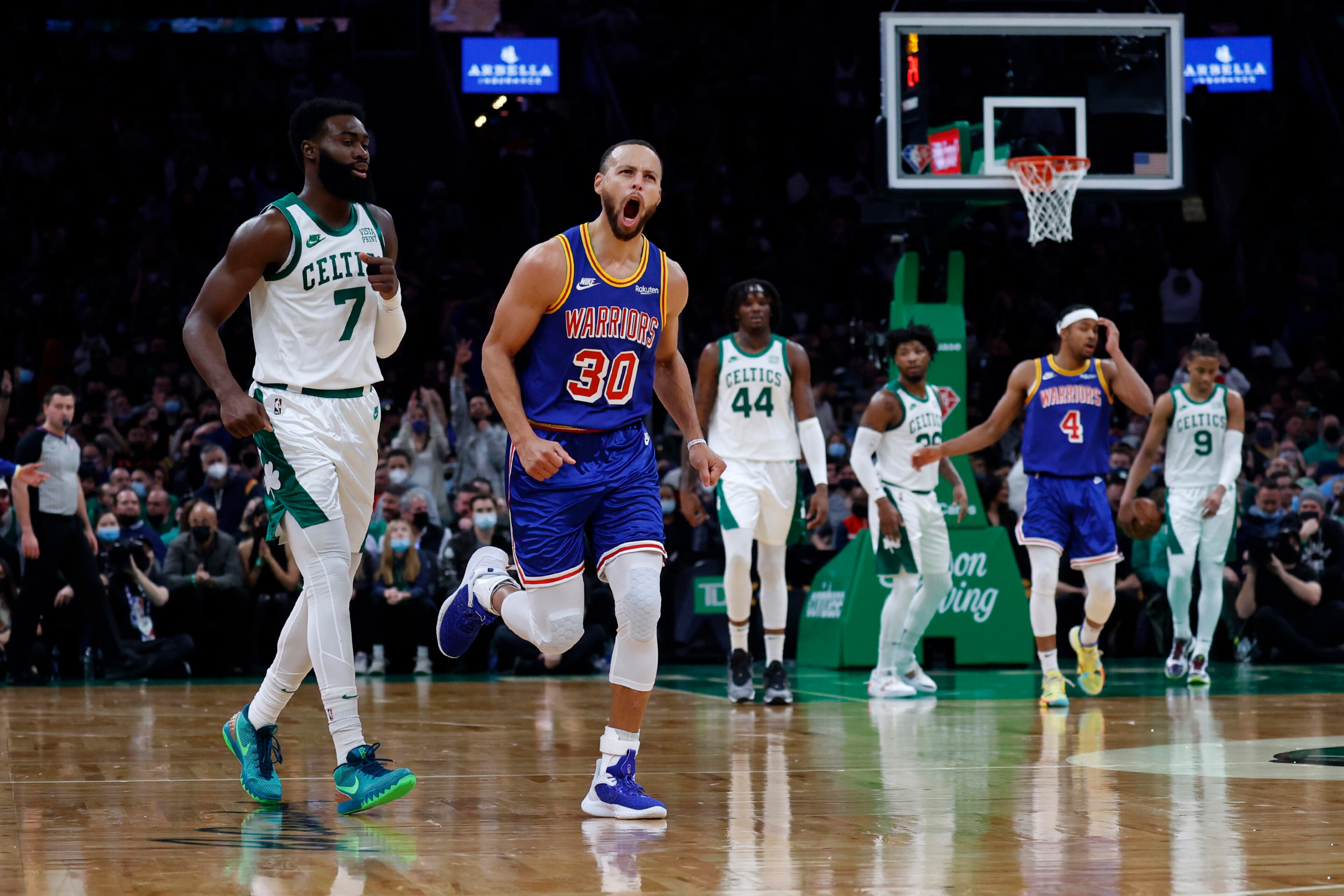 Golden State Warriors guard Stephen Curry (30) reacts after hitting a three point shot as Boston Celtics guard Jaylen Brown (7) looks on during the first half of an NBA basketball game, Friday, Dec. 17, 2021, in Boston. (AP Photo/Mary Schwalm) Golden State Warriors guard Stephen Curry (30) reacts after hitting a three point shot as Boston Celtics guard Jaylen Brown (7) looks on during the first half of an NBA basketball game, Friday, Dec. 17, 2021, in Boston. (AP Photo/Mary Schwalm)