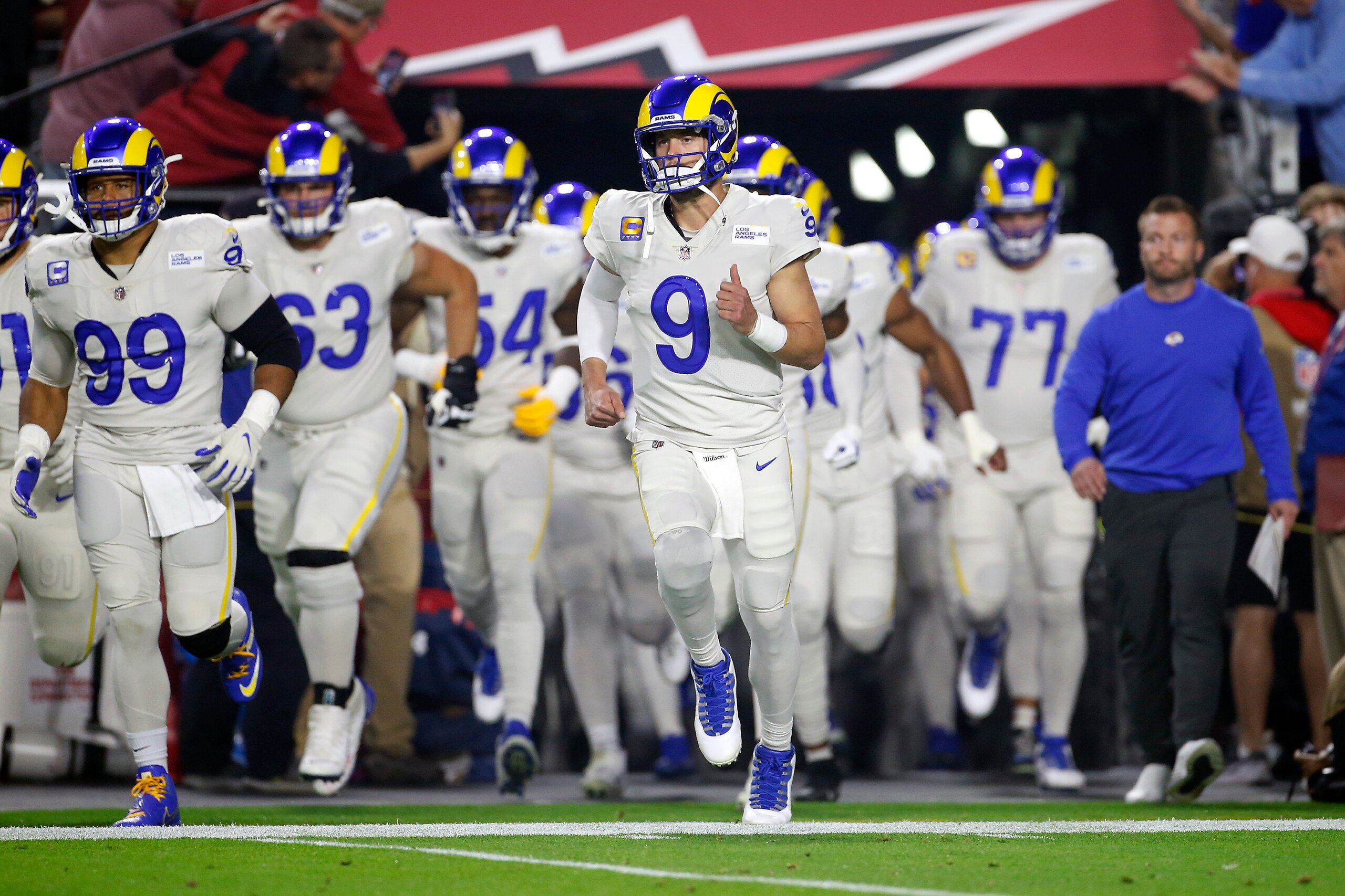 Los Angeles Rams quarterback Matthew Stafford (9) leads the team on to the field prior to an NFL football game against the Arizona Cardinals, Monday, Dec. 13, 2021, in Glendale, Ariz. (AP Photo/Ralph Freso)