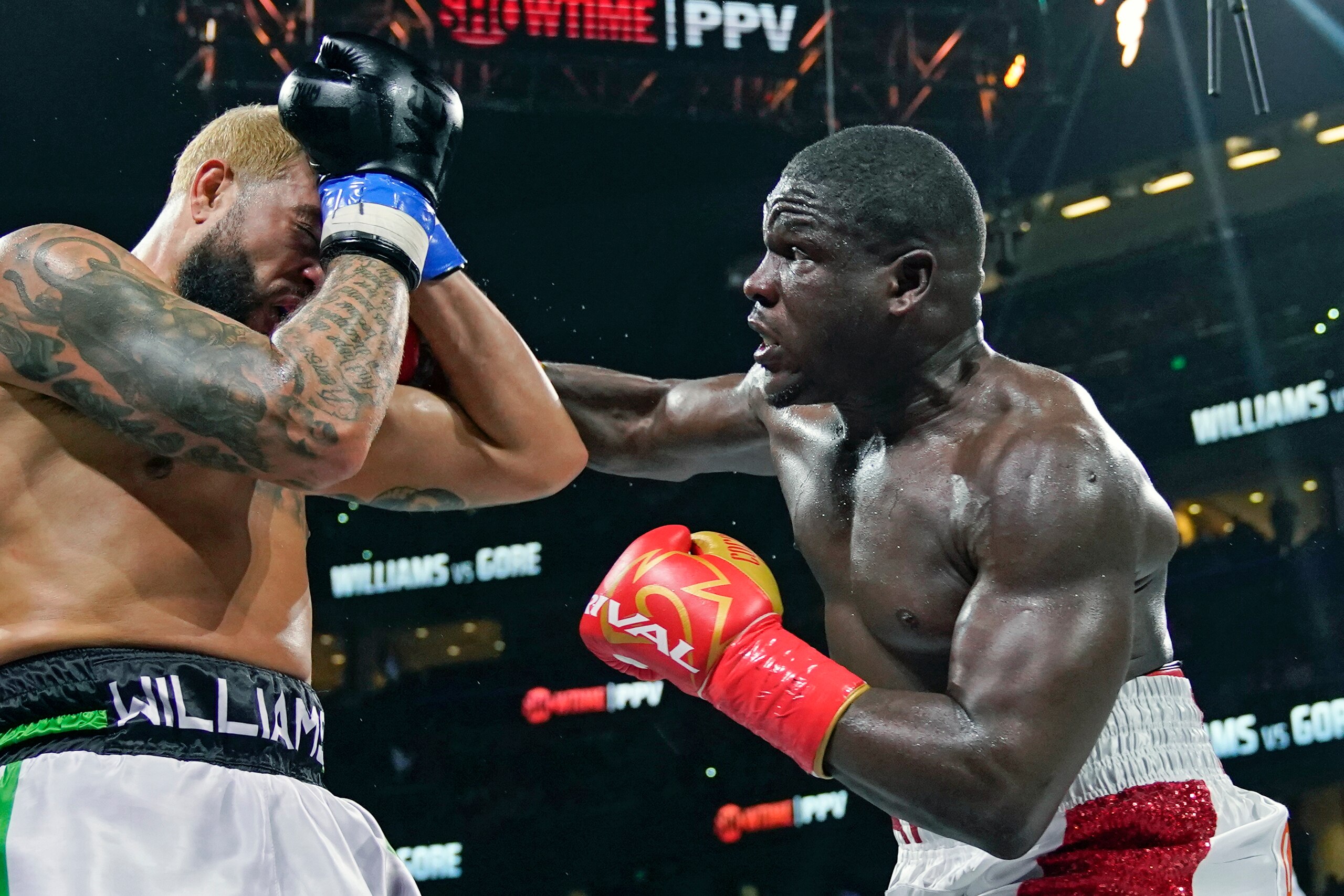 Frank Gore, right, lands a punch on Deron Williams during the fourth round of a heavyweight special attraction fight Saturday, Dec. 18, 2021, in Tampa, Fla. (AP Photo/Chris O'Meara)