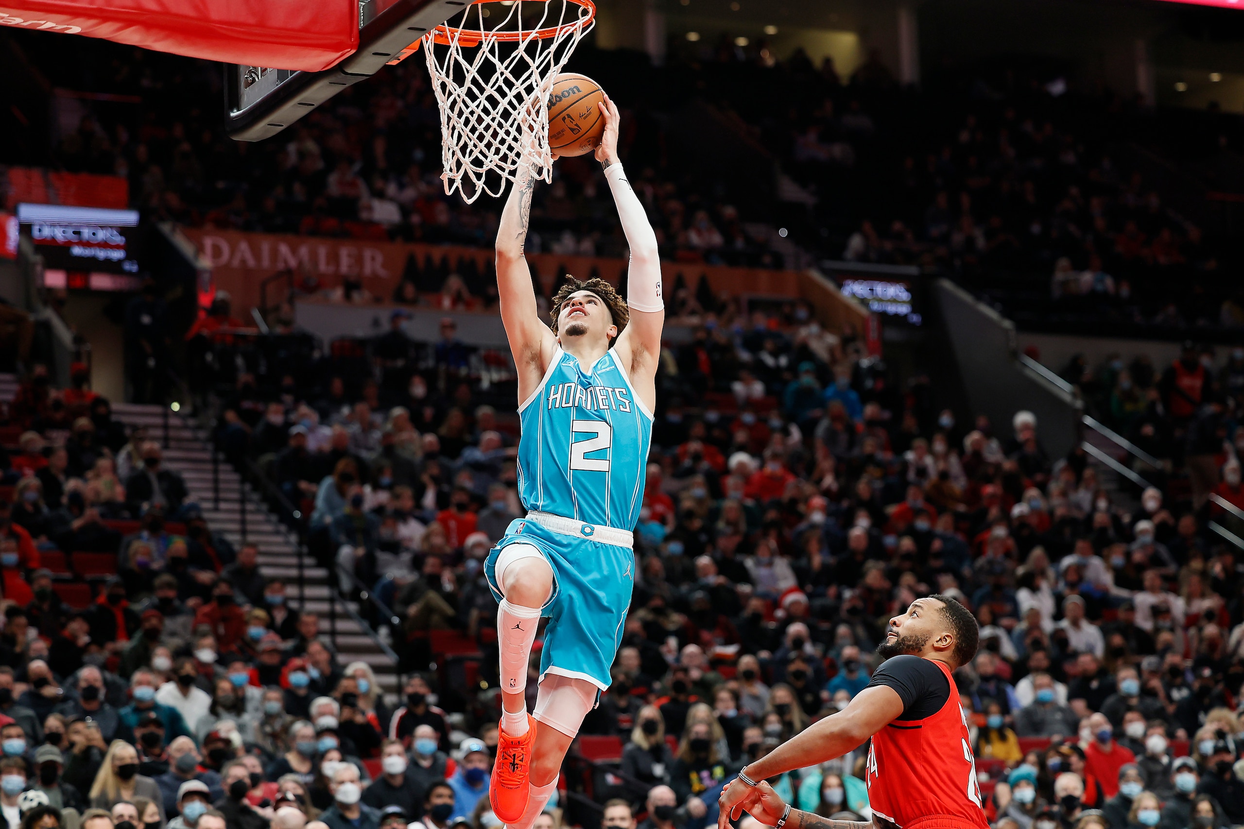 PORTLAND, OREGON - DECEMBER 17: LaMelo Ball # 2 of the Charlotte Hornets dunks the ball past Norman Powell # 24 of the Portland Trail Blazers during the second half against the Portland Trail Blazers at Moda Center on December 17, 2021 in Portland, Oregon. NOTE TO USER: User expressly acknowledges and agrees that, by downloading and or using this photograph, User is consenting to the terms and conditions of the Getty Images License Agreement. (Photo by Soobum Im/Getty Images) PORTLAND, OREGON - DECEMBER 17: LaMelo Ball # 2 of the Charlotte Hornets dunks the ball past Norman Powell # 24 of the Portland Trail Blazers during the second half against the Portland Trail Blazers at Moda Center on December 17, 2021 in Portland, Oregon. NOTE TO USER: User expressly acknowledges and agrees that, by downloading and or using this photograph, User is consenting to the terms and conditions of the Getty Images License Agreement. (Photo by Soobum Im/Getty Images)