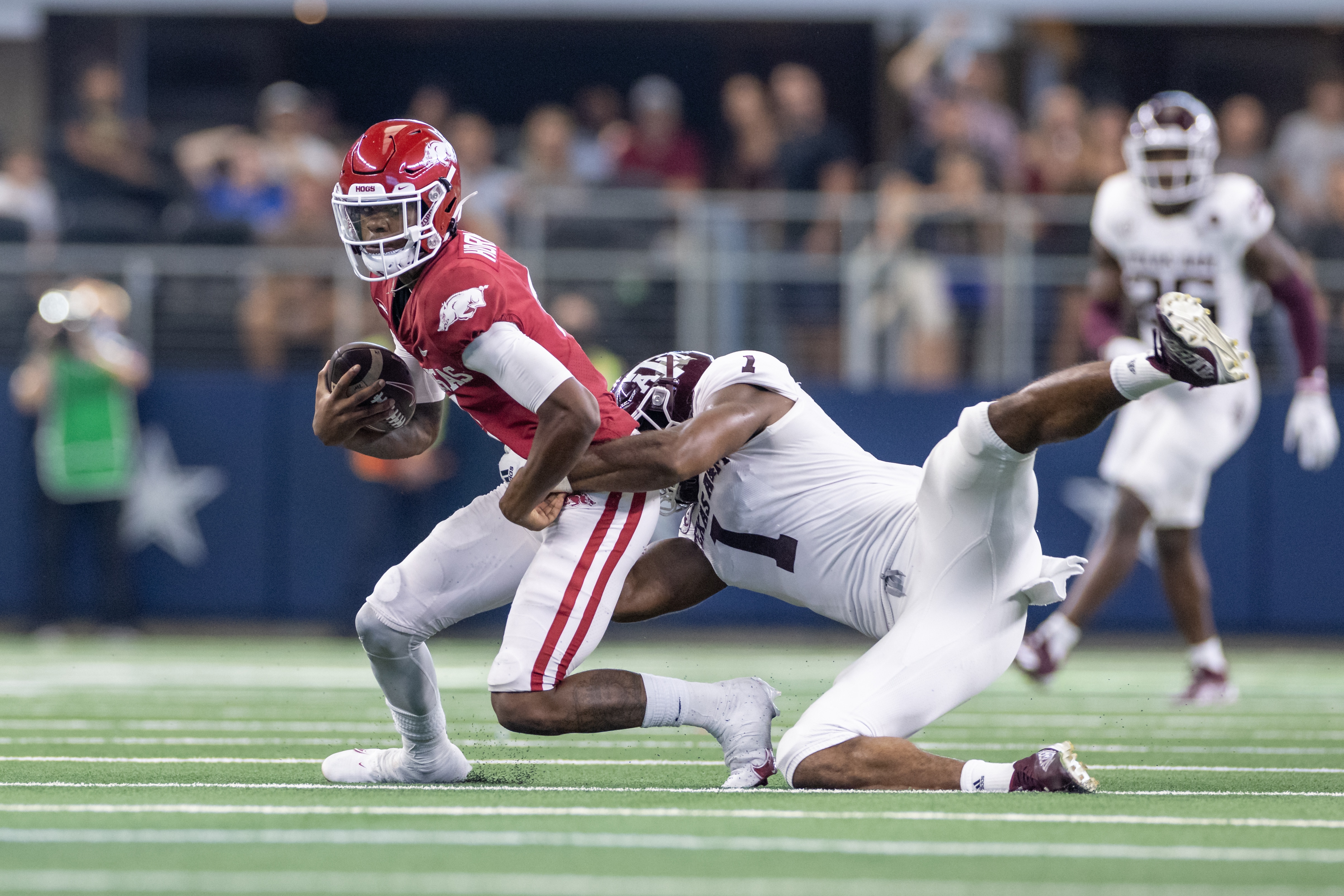 ARLINGTON, TX - SEPTEMBER 25: Arkansas Razorbacks quarterback Malik Hornsby (#4) is tackled by Texas A&M Aggies linebacker Aaron Hansford (#1) during the  Southwest Classic college football game between the Texas A&M Aggies and Arkansas Razorbacks on September 25, 2021 at AT&T Stadium in Arlington, TX.  (Photo by Matthew Visinsky/Icon Sportswire via Getty Images)