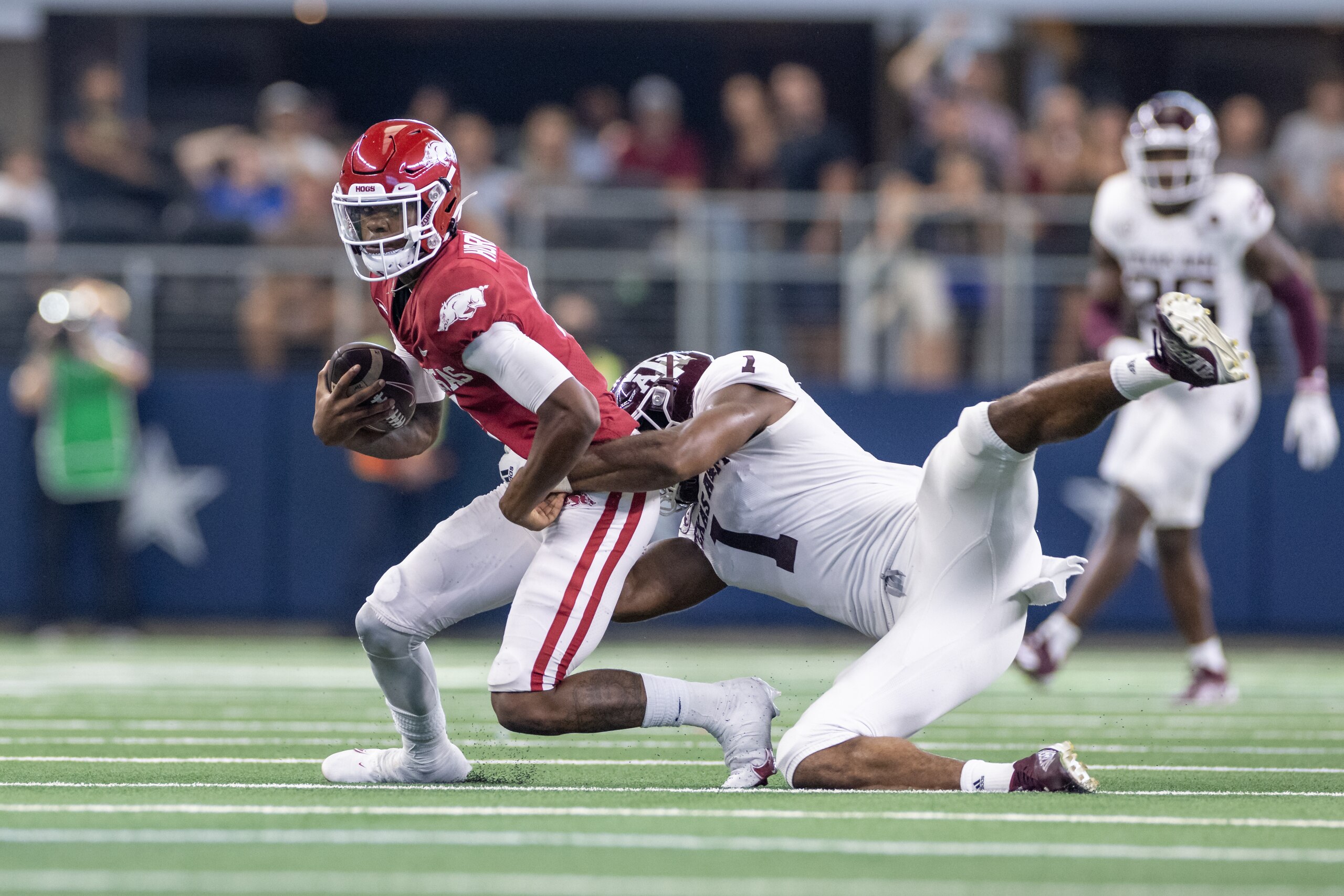 ARLINGTON, TX - SEPTEMBER 25: Arkansas Razorbacks quarterback Malik Hornsby (#4) is tackled by Texas A&M Aggies linebacker Aaron Hansford (#1) during the  Southwest Classic college football game between the Texas A&M Aggies and Arkansas Razorbacks on September 25, 2021 at AT&T Stadium in Arlington, TX.  (Photo by Matthew Visinsky/Icon Sportswire via Getty Images)