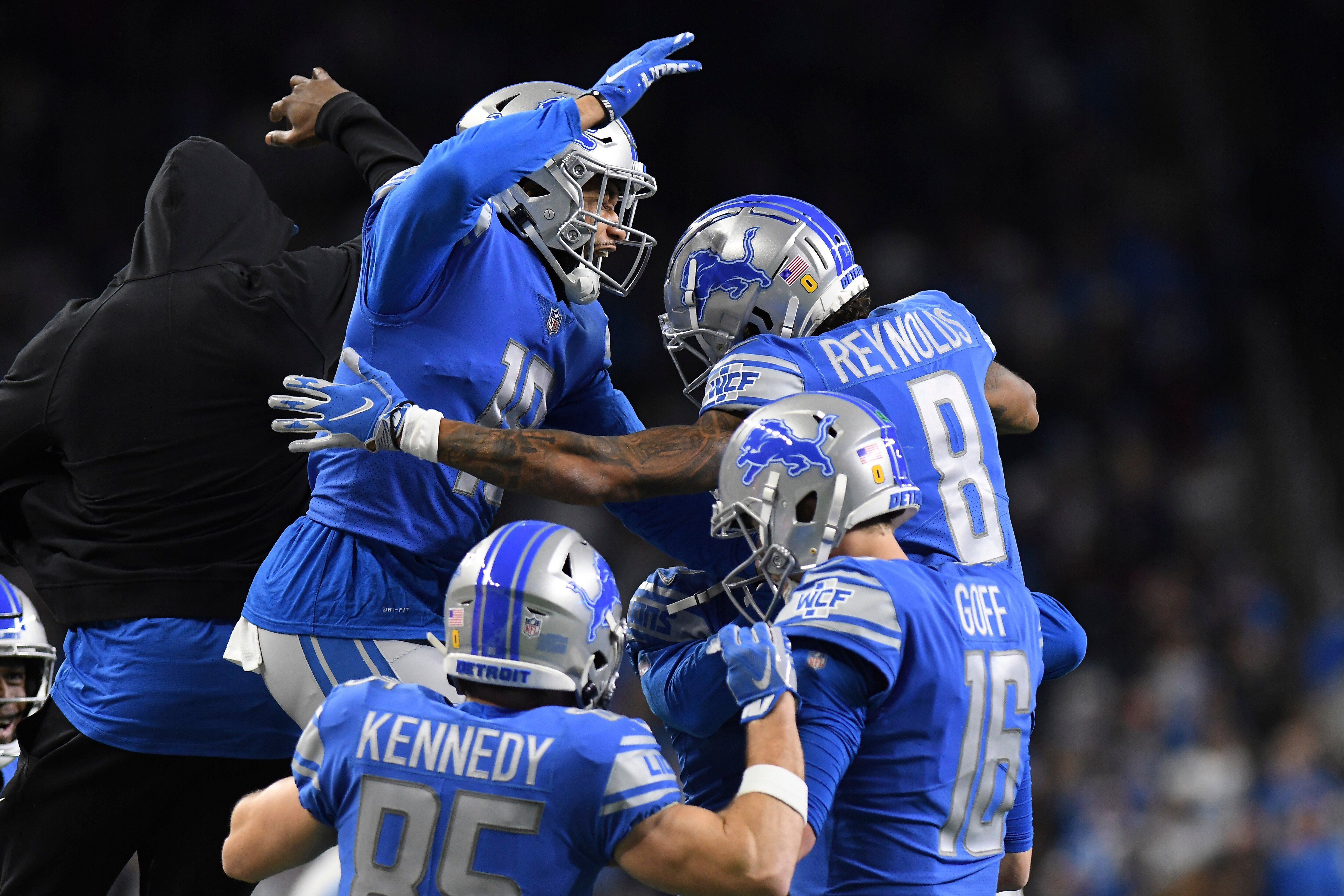 Teammates congratulate Detroit Lions wide receiver Josh Reynolds (8) after his touchdown during the first half of an NFL football game against the Arizona Cardinals, Sunday, Dec. 19, 2021, in Detroit. (AP Photo/Lon Horwedel)