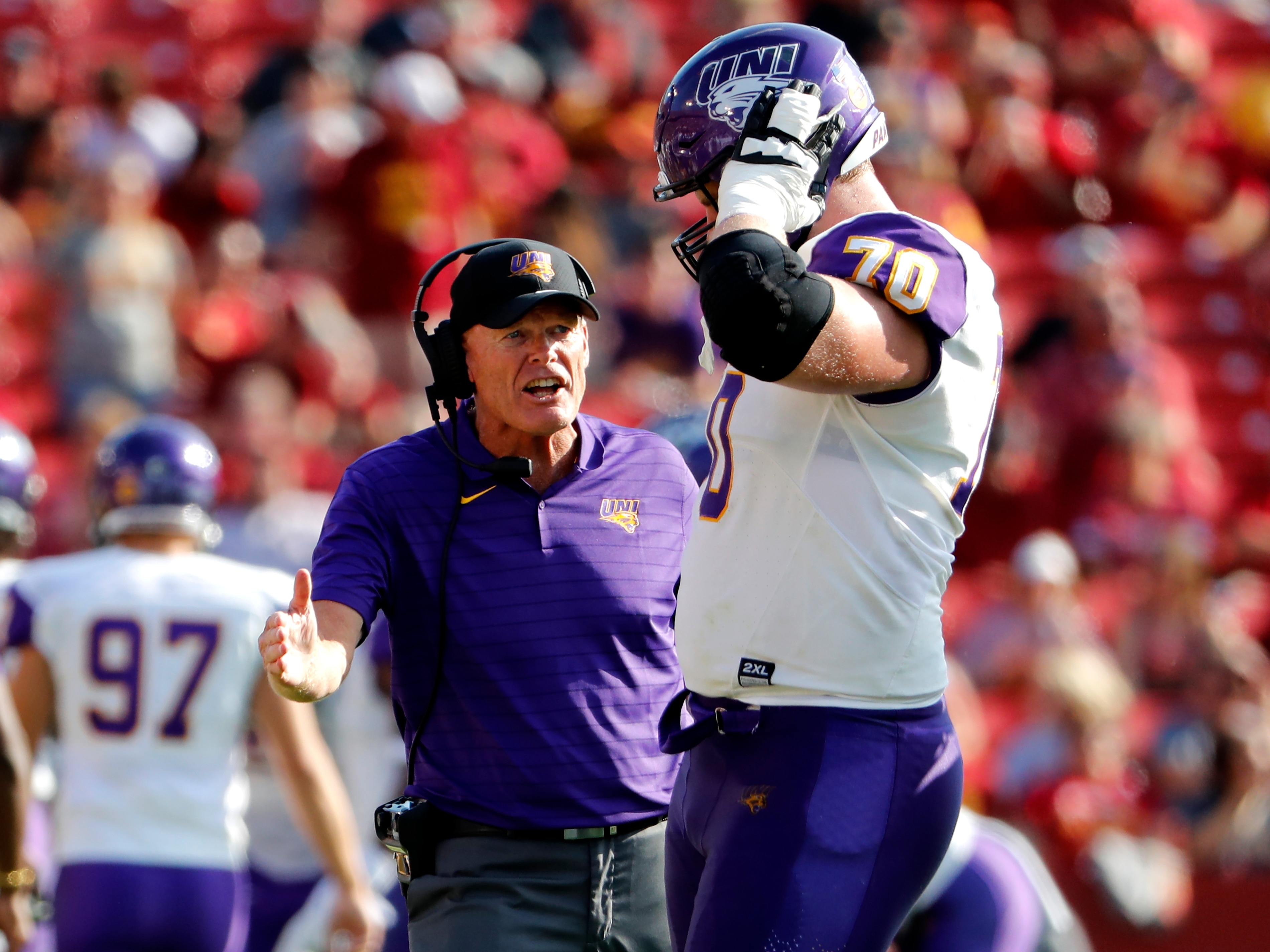 AMES, IA - SEPTEMBER 4: Head coach Mark Farley of the Northern Iowa Panthers co0aches offensive lineman Trevor Penning #70 of the Northern Iowa Panthers on the sidelines in the first half of play against the Iowa State Cyclones at Jack Trice Stadium on September 4, 2021 in Ames, Iowa. (Photo by David Purdy/Getty Images)