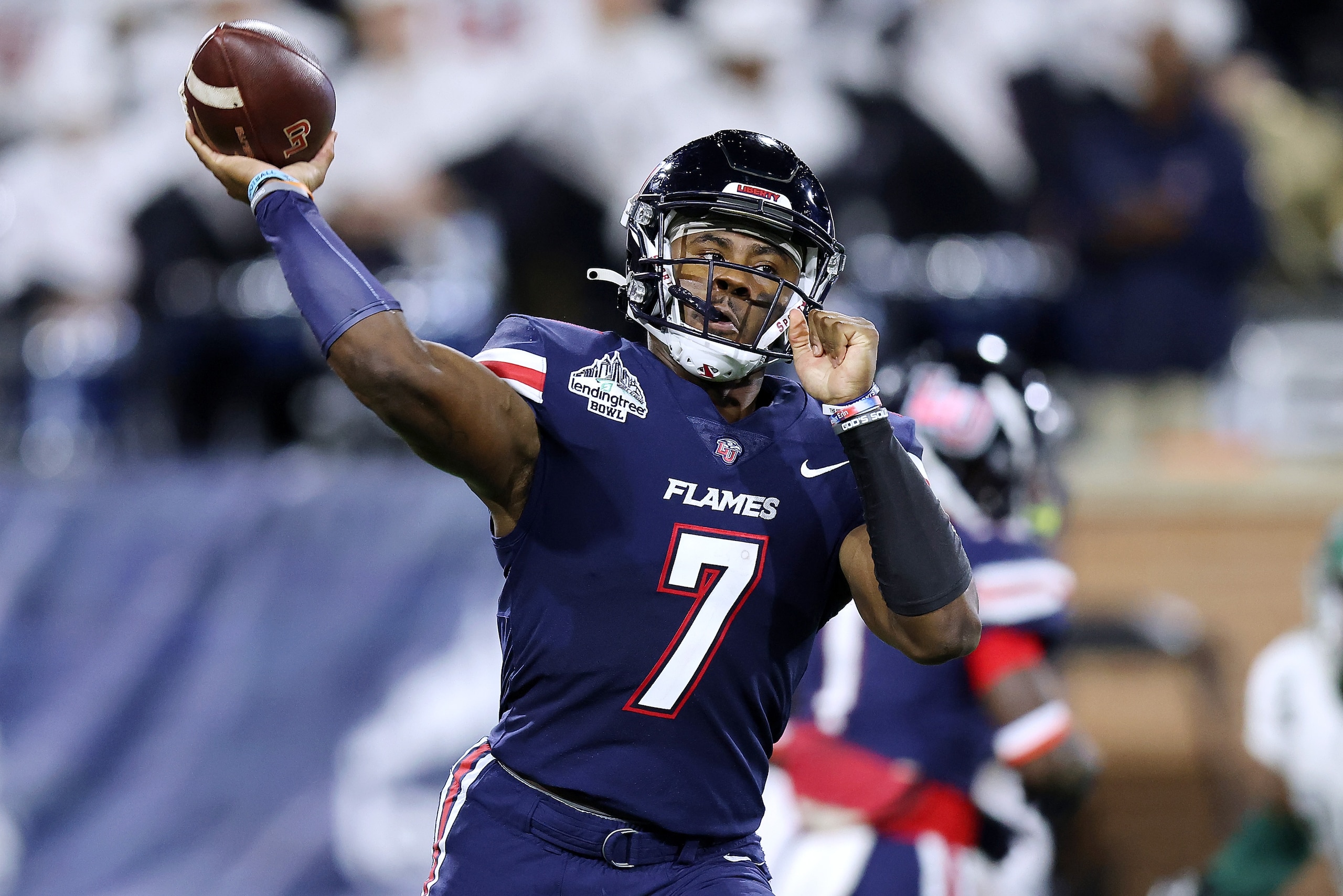 MOBILE, ALABAMA - DECEMBER 18: Malik Willis #7 of the Liberty Flames throws the ball during the first half of the LendingTree Bowl against the Eastern Michigan Eagles at Hancock Whitney Stadium on December 18, 2021 in Mobile, Alabama. (Photo by Jonathan Bachman/Getty Images) MOBILE, ALABAMA - DECEMBER 18: Malik Willis #7 of the Liberty Flames throws the ball during the first half of the LendingTree Bowl against the Eastern Michigan Eagles at Hancock Whitney Stadium on December 18, 2021 in Mobile, Alabama. (Photo by Jonathan Bachman/Getty Images)