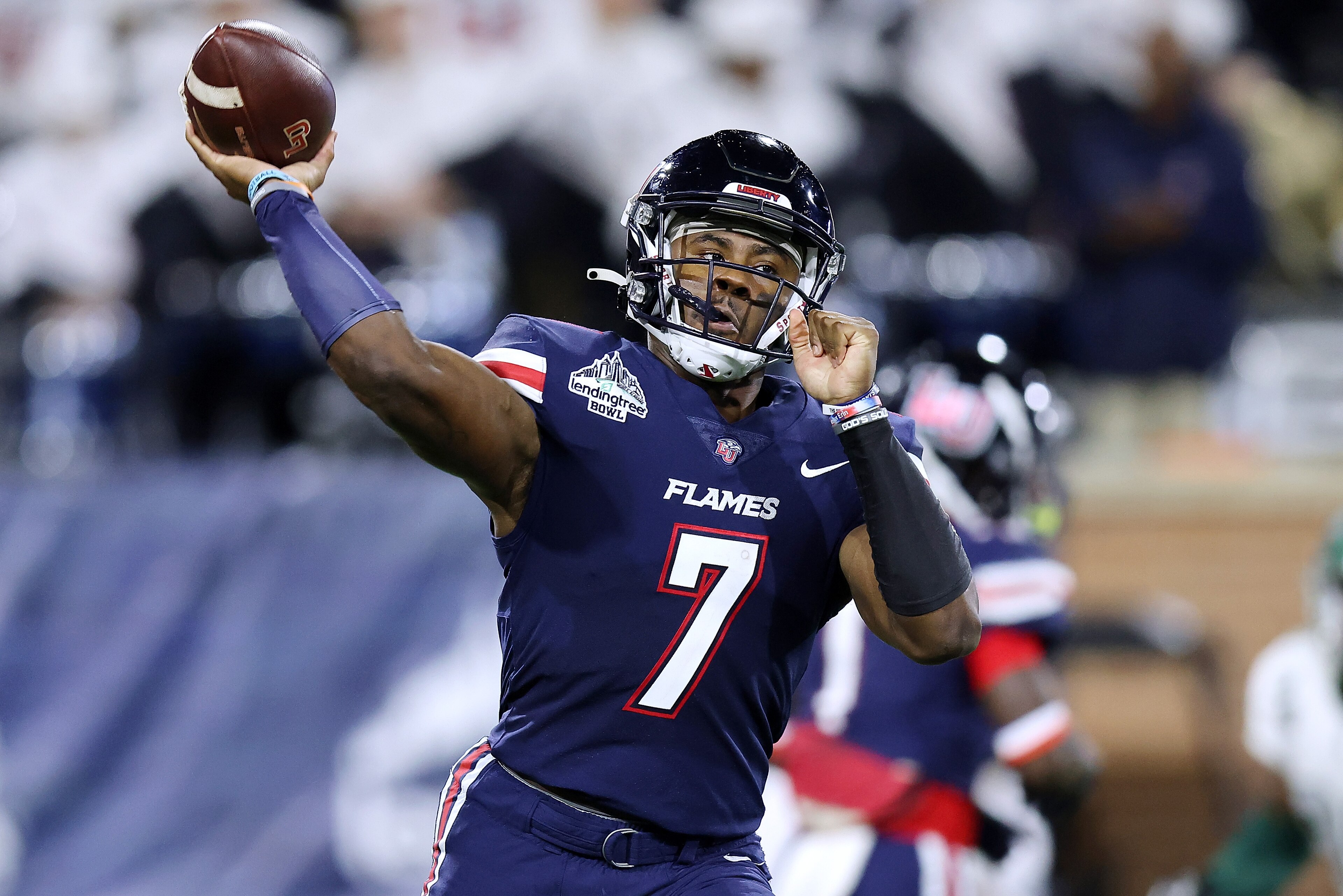 MOBILE, ALABAMA - DECEMBER 18: Malik Willis #7 of the Liberty Flames throws the ball during the first half of the LendingTree Bowl against the Eastern Michigan Eagles at Hancock Whitney Stadium on December 18, 2021 in Mobile, Alabama. (Photo by Jonathan Bachman/Getty Images) MOBILE, ALABAMA - DECEMBER 18: Malik Willis #7 of the Liberty Flames throws the ball during the first half of the LendingTree Bowl against the Eastern Michigan Eagles at Hancock Whitney Stadium on December 18, 2021 in Mobile, Alabama. (Photo by Jonathan Bachman/Getty Images)