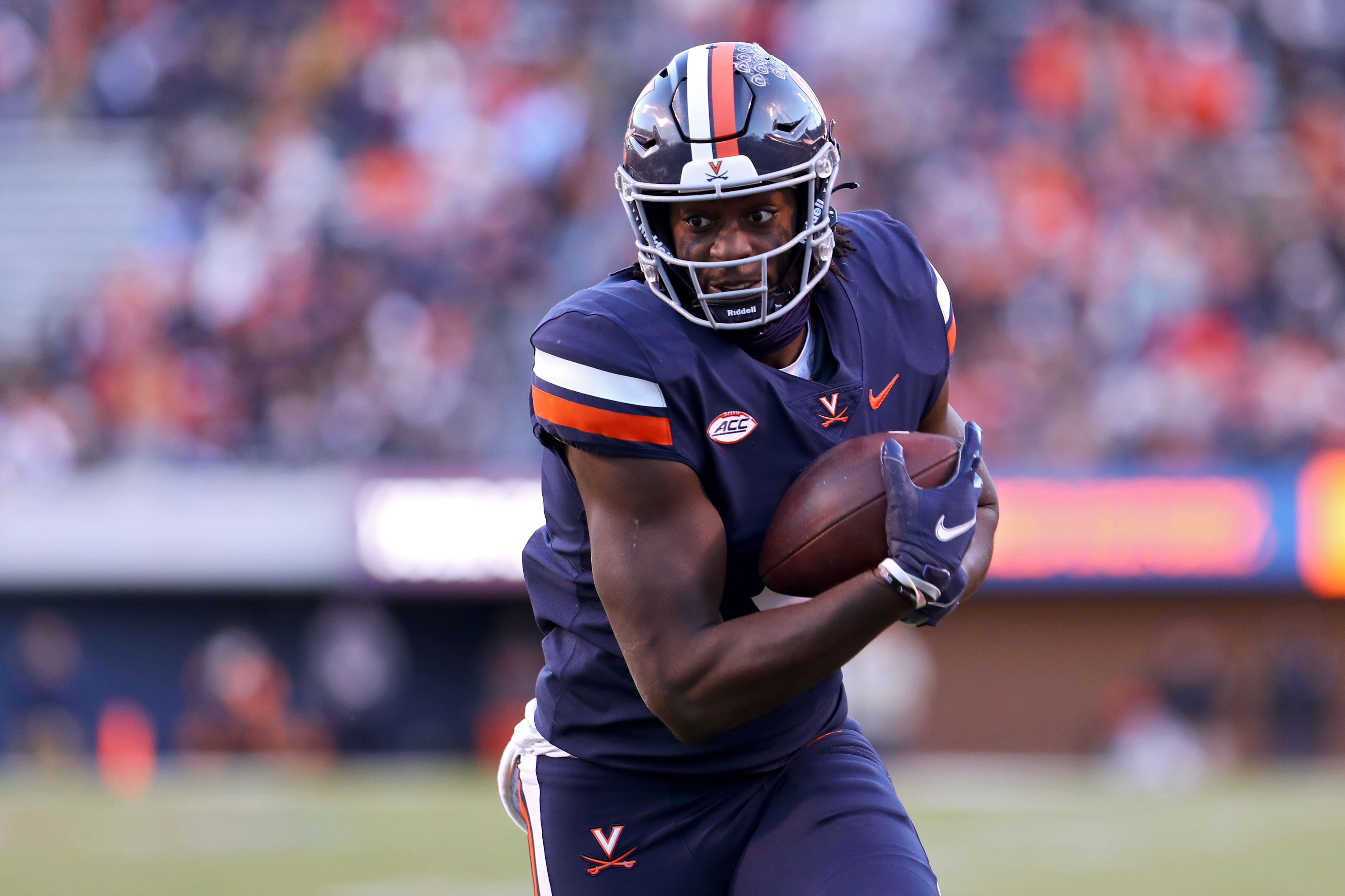 CHARLOTTESVILLE, VA - NOVEMBER 27: Jelani Woods #0 of the Virginia Cavaliers catches a pass in the first half during a game against the Virginia Tech Hokies at Scott Stadium on November 27, 2021 in Charlottesville, Virginia. (Photo by Ryan M. Kelly/Getty Images)
