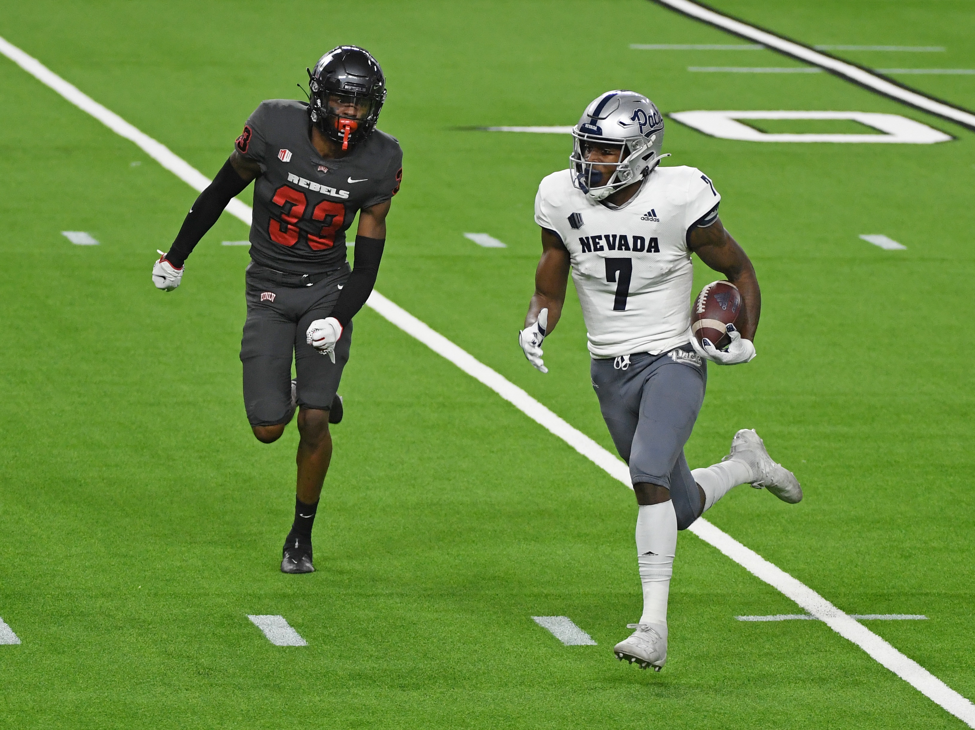 LAS VEGAS, NEVADA - OCTOBER 31:  Wide receiver Romeo Doubs #7 of the Nevada Wolf Pack scores a touchdown on a 65-yard pass play against defensive back Sir Oliver Everett #33 of the UNLV Rebels in the first half of their game at Allegiant Stadium on October 31, 2020 in Las Vegas, Nevada.  (Photo by Ethan Miller/Getty Images)