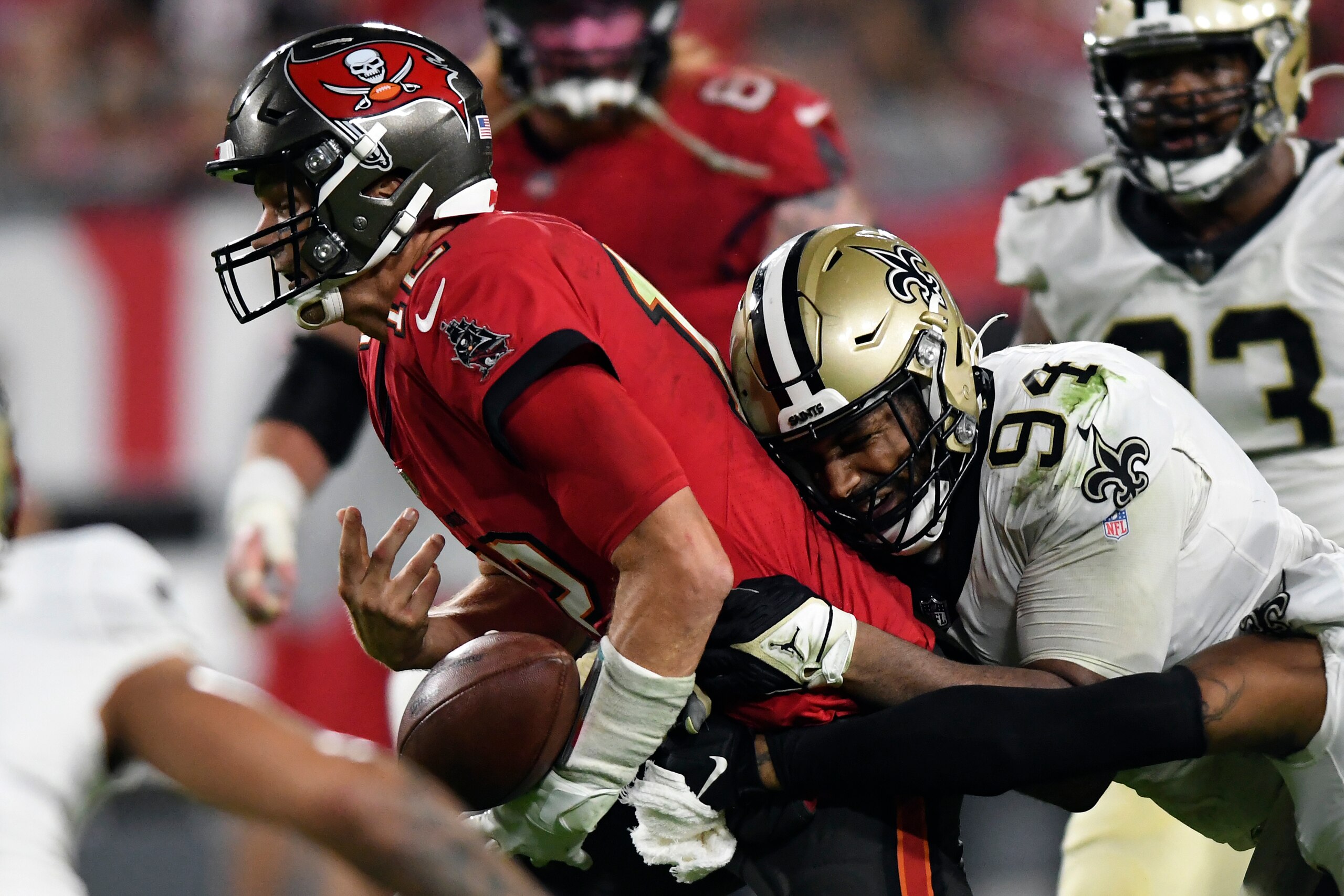 Tampa Bay Buccaneers quarterback Tom Brady (12) fumbles the football after getting hit by New Orleans Saints defensive end Cameron Jordan (94) during the second half of an NFL football game Sunday, Dec. 19, 2021, in Tampa, Fla. (AP Photo/Jason Behnken)