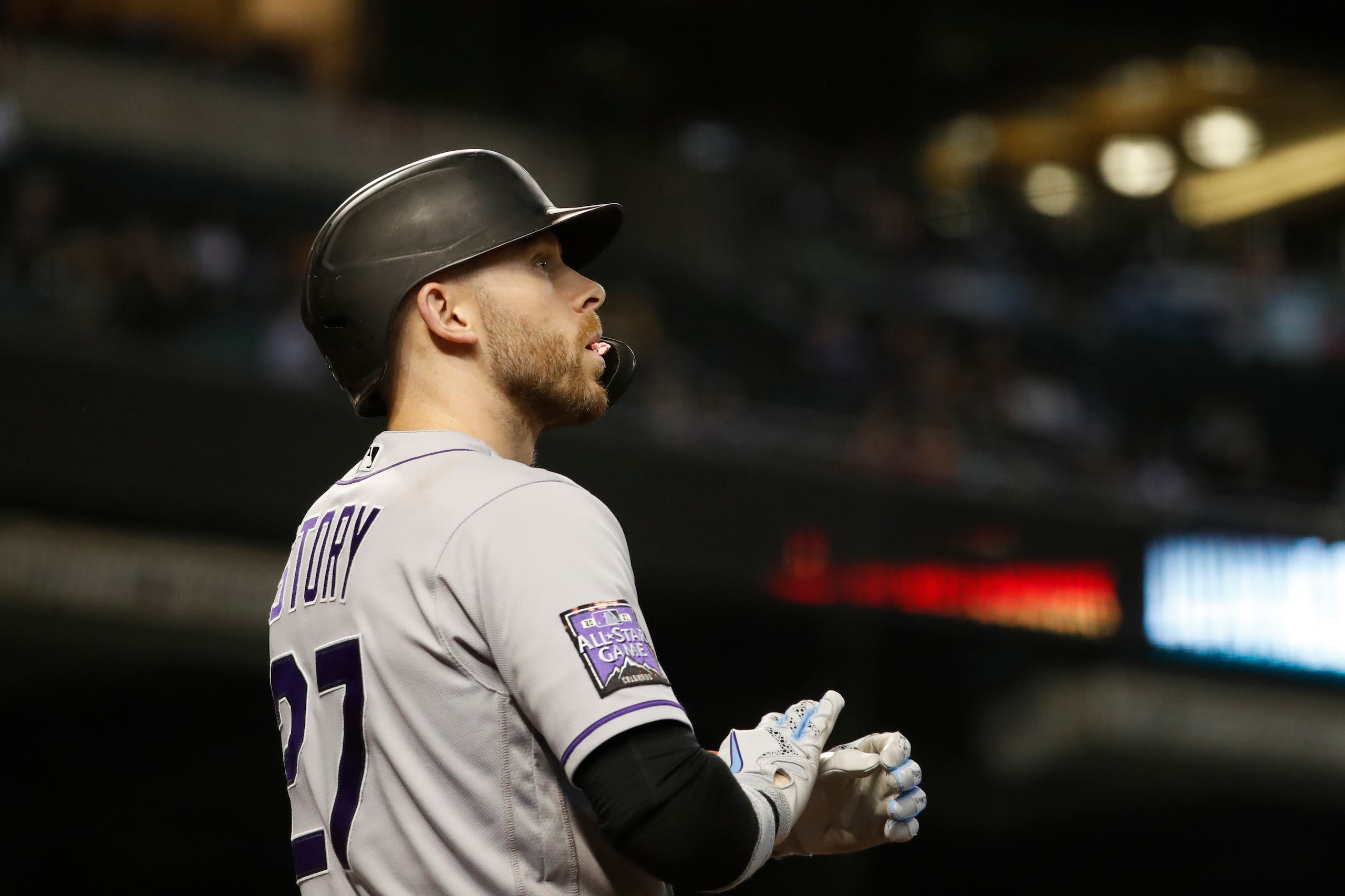 PHOENIX, ARIZONA - OCTOBER 02: Trevor Story #27 of the Colorado Rockies adjusts his gloves during the game against the Arizona Diamondbacks at Chase Field on October 02, 2021 in Phoenix, Arizona. (Photo by Chris Coduto/Getty Images)