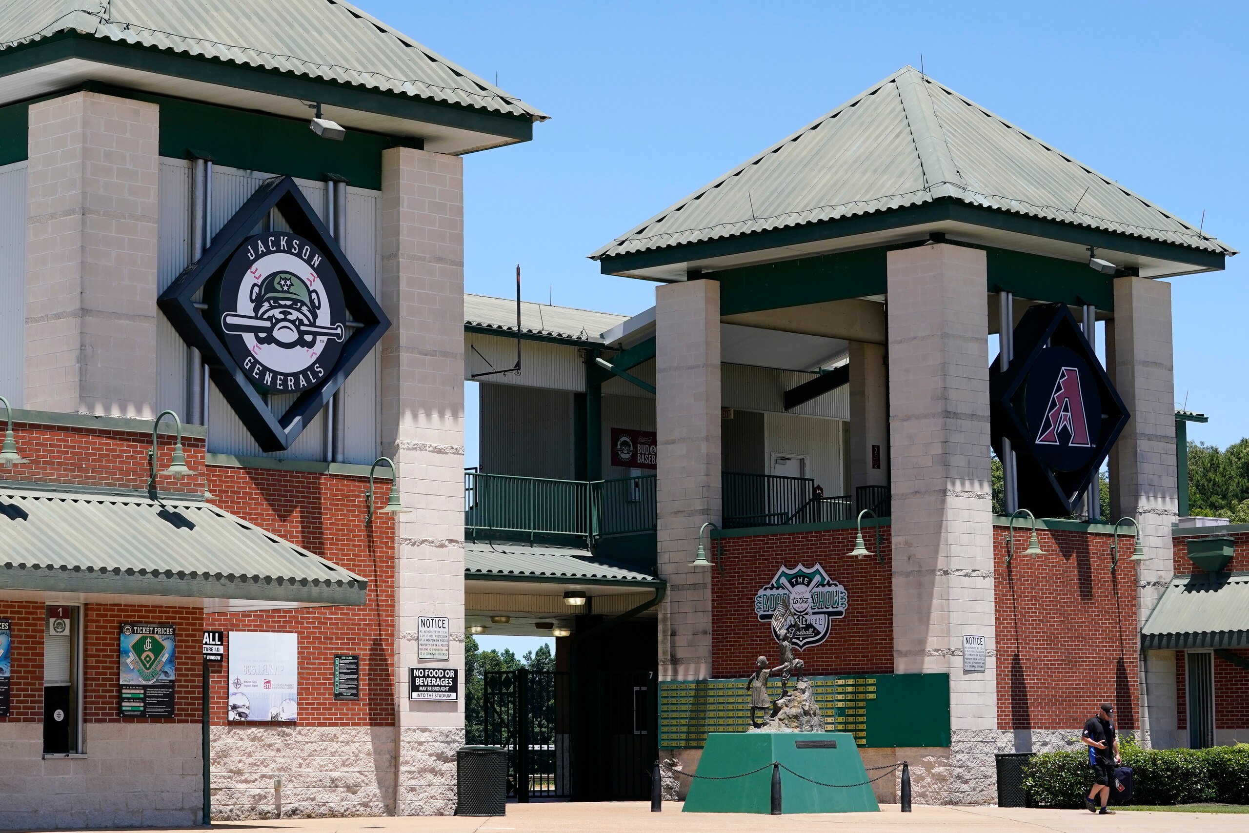 Logos for the Jackson Generals and the Arizona Diamondbacks are displayed at the entrance to The Ballpark at Jackson on Tuesday, June 22, 2021, in Jackson, Tenn. When Major League Baseball stripped 40 teams of their affiliation in a drastic shakeup of the minor leagues this winter, Jackson lost the Generals, the Double-A affiliate of the Diamondbacks. (AP Photo/Mark Humphrey) Logos for the Jackson Generals and the Arizona Diamondbacks are displayed at the entrance to The Ballpark at Jackson on Tuesday, June 22, 2021, in Jackson, Tenn. When Major League Baseball stripped 40 teams of their affiliation in a drastic shakeup of the minor leagues this winter, Jackson lost the Generals, the Double-A affiliate of the Diamondbacks. (AP Photo/Mark Humphrey)