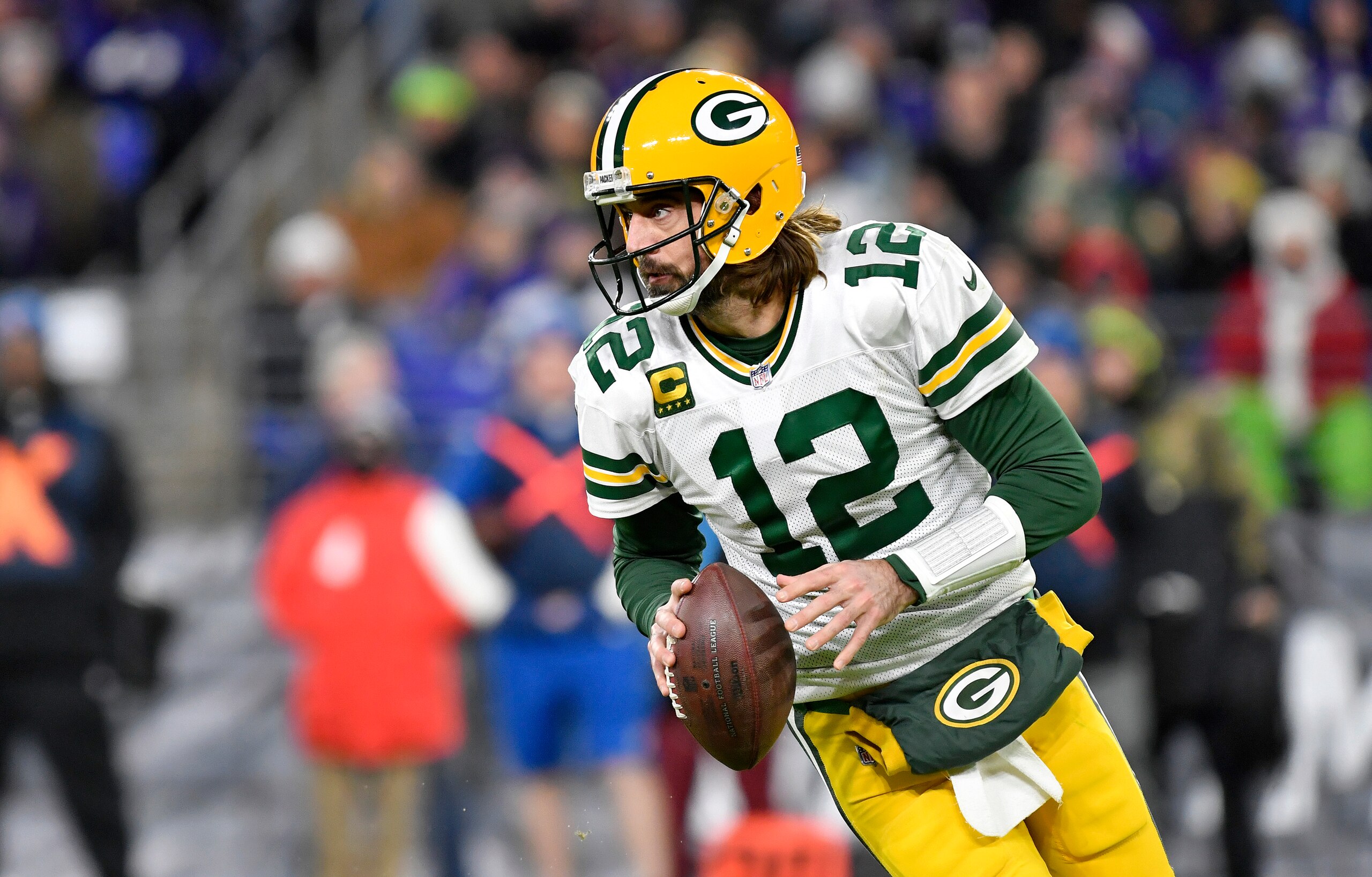 BALTIMORE, MD - DECEMBER 19: Packers quarterback Aaron Rodgers (12) rolls out to pass during the Green Bay Packers versus Baltimore Ravens NFL game at M&T Bank Stadium on December 19, 2021 in Baltimore, MD. (Photo by Randy Litzinger/Icon Sportswire via Getty Images)