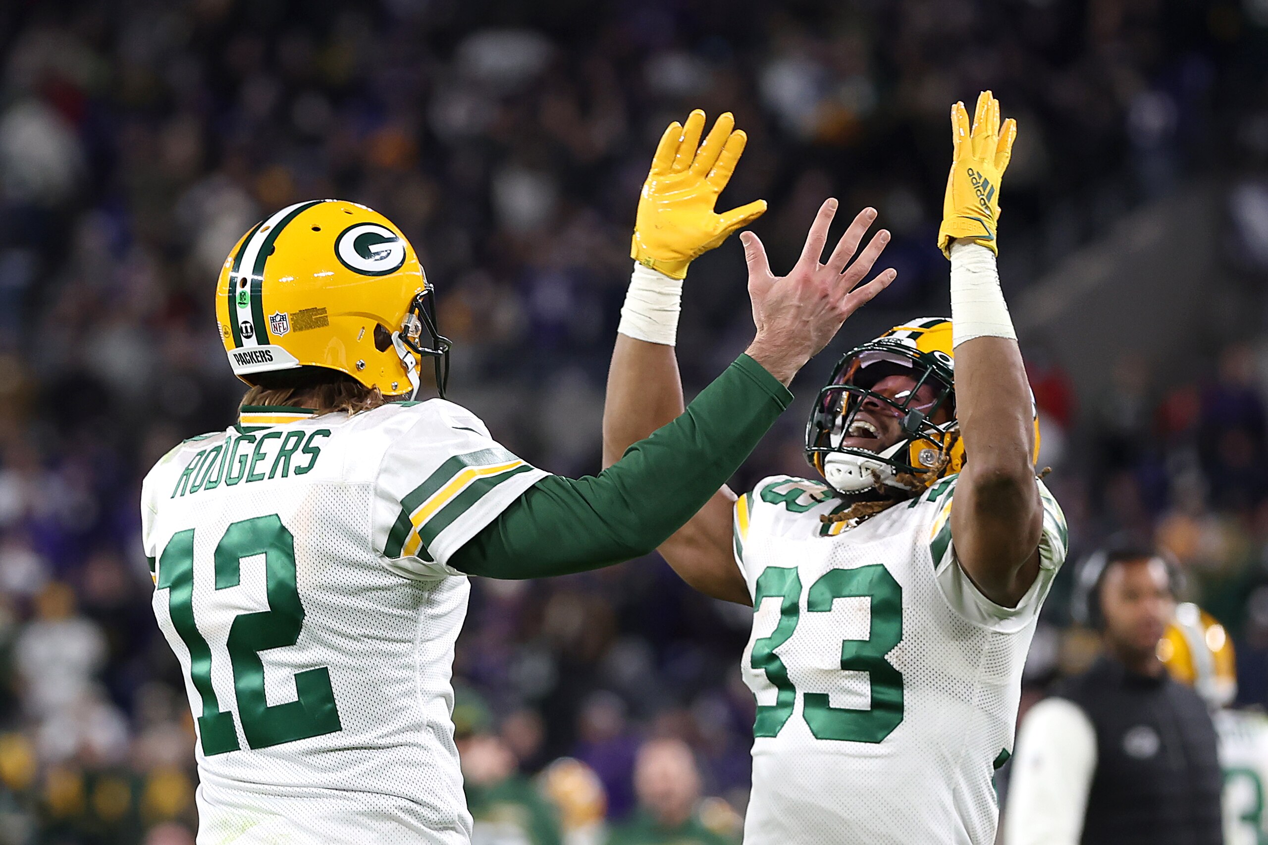 BALTIMORE, MARYLAND - DECEMBER 19: Quarterback Aaron Rodgers #12 and running back Aaron Jones #33 of the Green Bay Packers celebrate a touchdown pass against the Baltimore Ravens in the first half at M&T Bank Stadium on December 19, 2021 in Baltimore, Maryland. (Photo by Rob Carr/Getty Images)