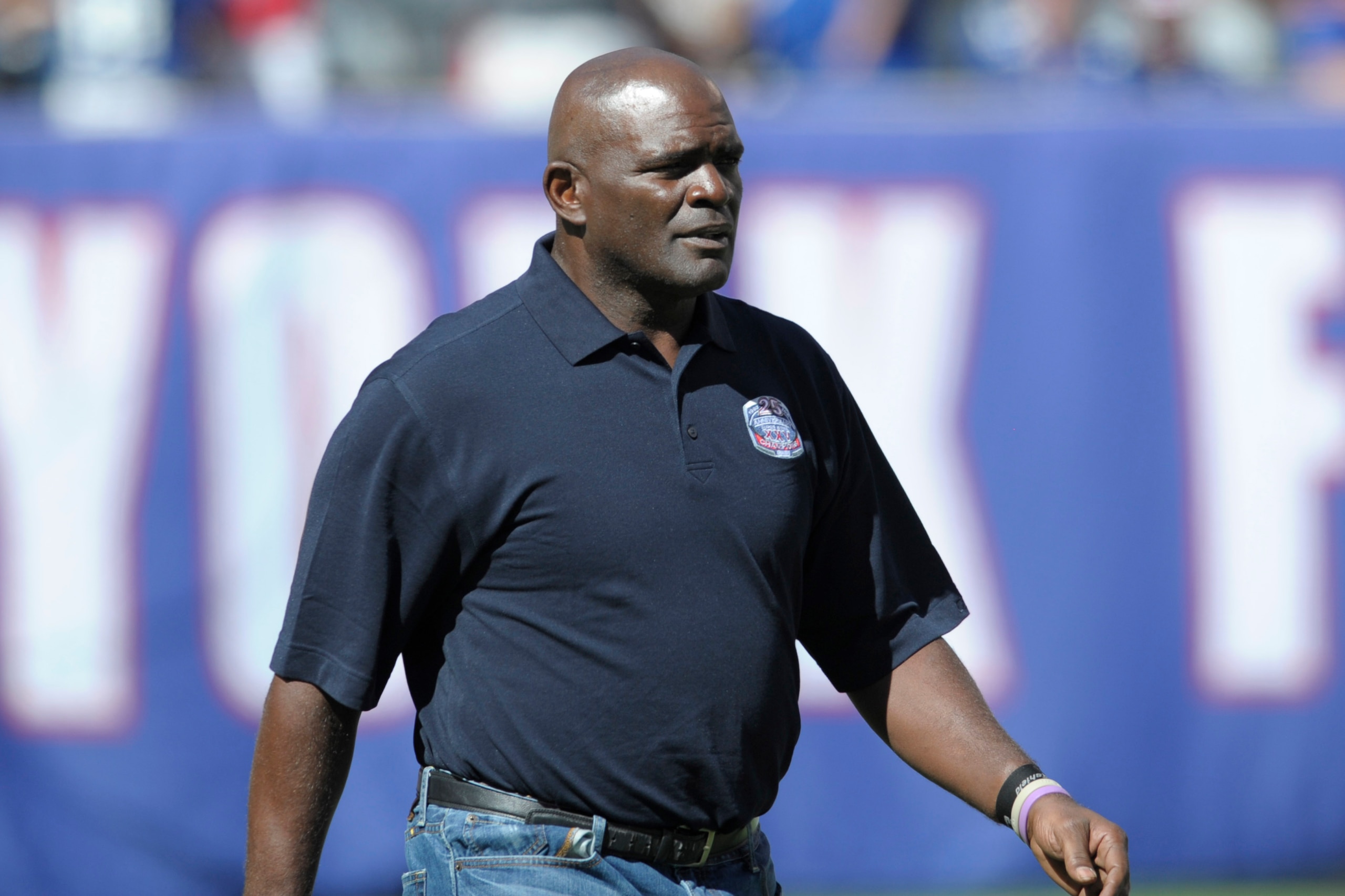 Former New York Giants' Lawrence Taylor walks onto the field during a 25 year anniversary celebration at halftime of an NFL football game against the Atlanta Falcons, Sunday, Sept. 20, 2015, in East Rutherford, N.J. (AP Photo/Bill Kostroun)