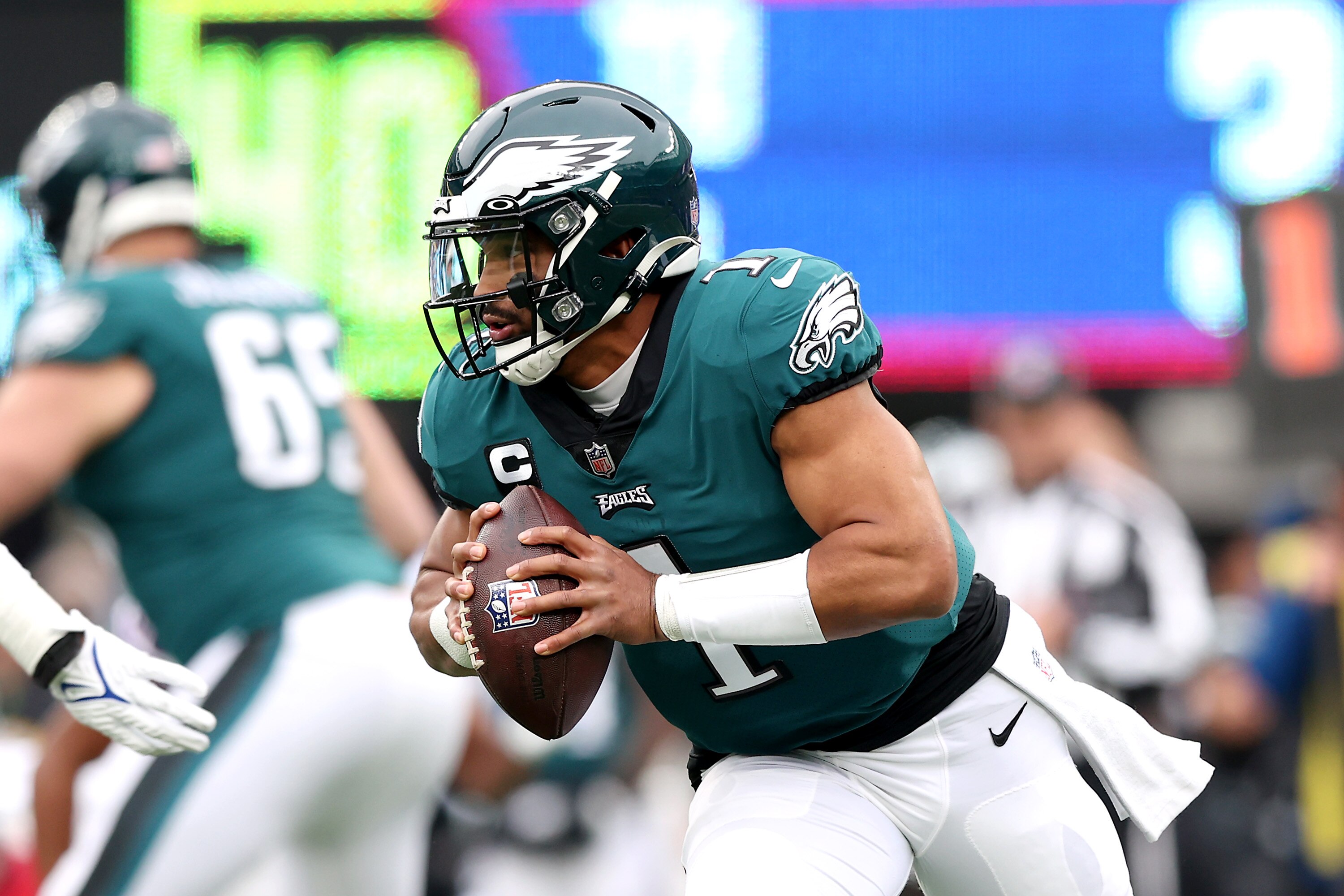 EAST RUTHERFORD, NEW JERSEY - NOVEMBER 28:  Jalen Hurts #1 of the Philadelphia Eagles scrambles for yardage in the first quarter against the New York Giants at MetLife Stadium on November 28, 2021 in East Rutherford, New Jersey. (Photo by Elsa/Getty Images)
