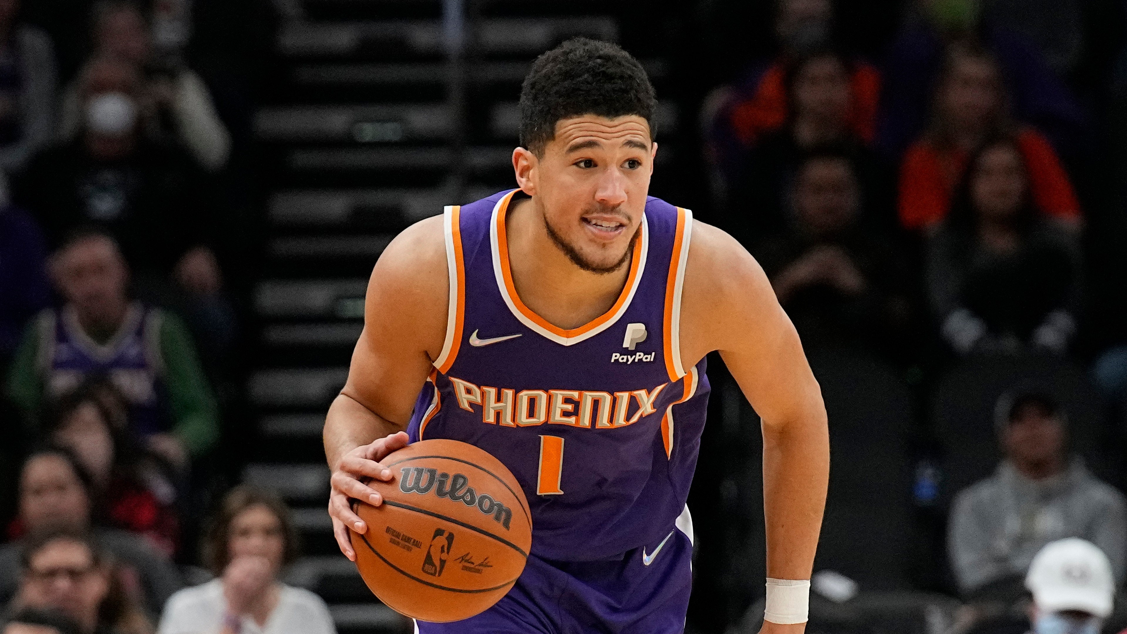 Phoenix Suns guard Devin Booker (1) during the first half of an NBA basketball game against the Charlotte Hornets, Sunday, Dec. 19, 2021, in Phoenix. (AP Photo/Rick Scuteri)