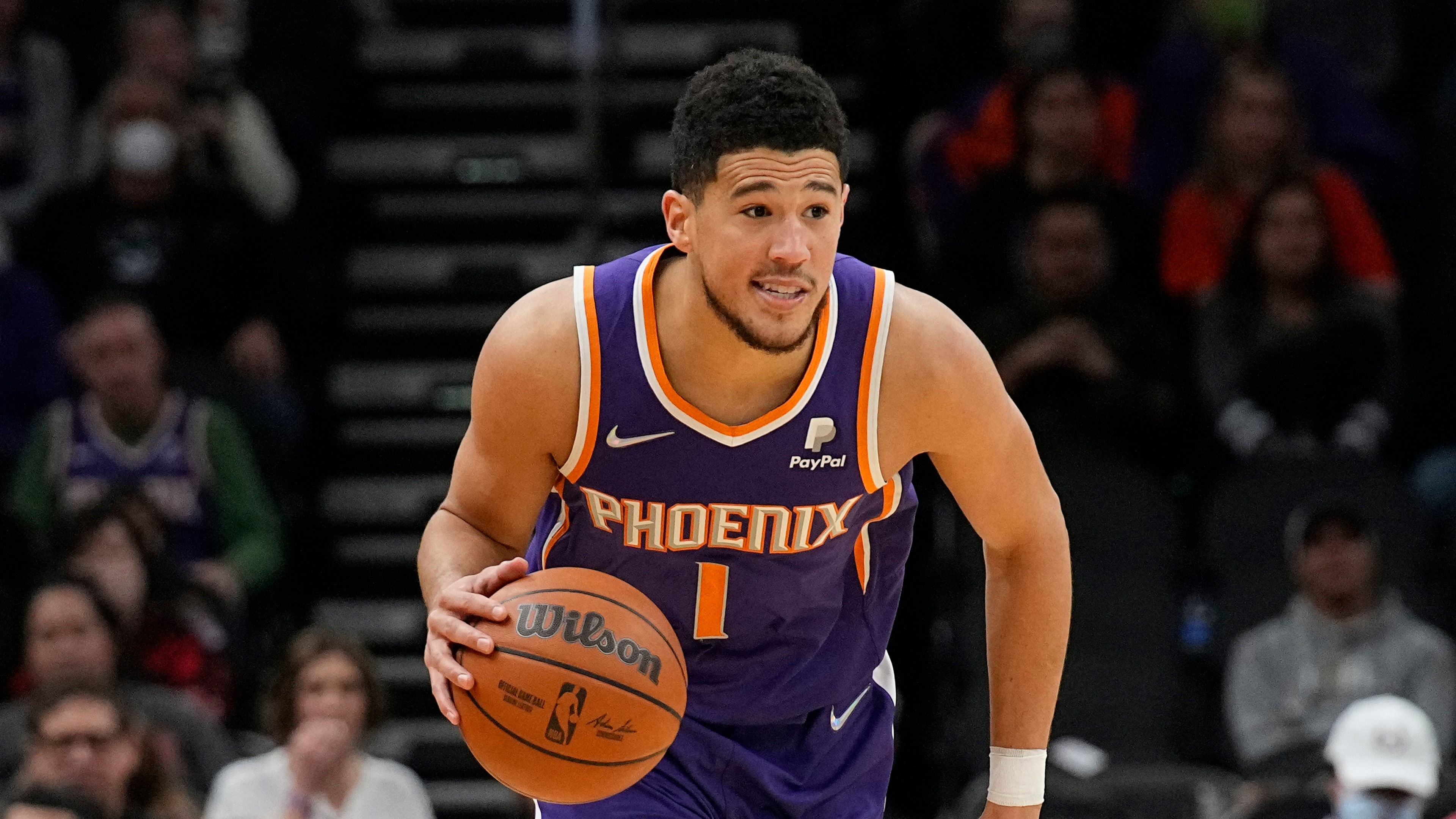 Phoenix Suns guard Devin Booker (1) during the first half of an NBA basketball game against the Charlotte Hornets, Sunday, Dec. 19, 2021, in Phoenix. (AP Photo/Rick Scuteri) Phoenix Suns guard Devin Booker (1) during the first half of an NBA basketball game against the Charlotte Hornets, Sunday, Dec. 19, 2021, in Phoenix. (AP Photo/Rick Scuteri)