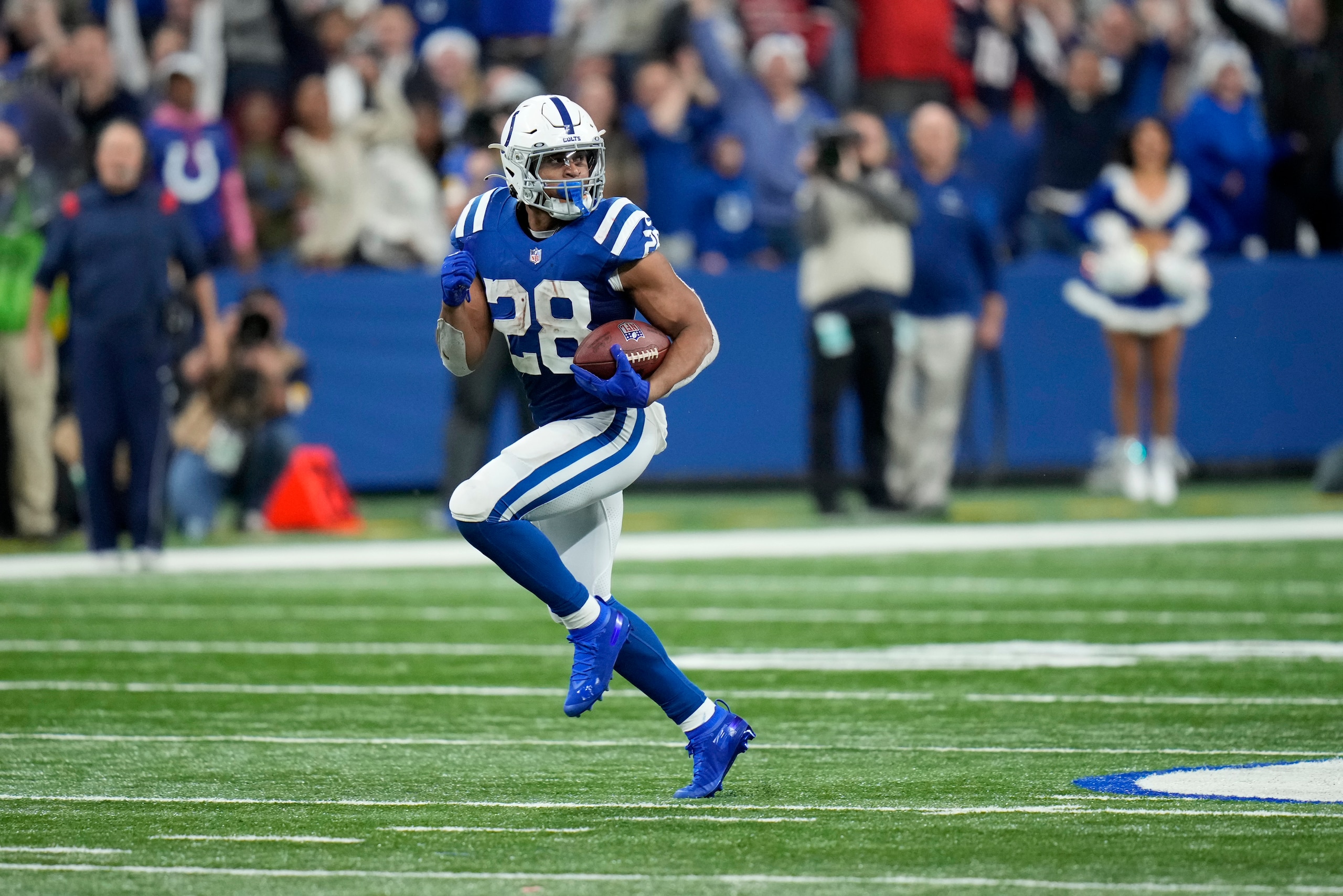 Indianapolis Colts running back Jonathan Taylor (28) runs for a 67-yard touchdown during the second half of an NFL football game against the New England Patriots Saturday, Dec. 18, 2021, in Indianapolis. (AP Photo/AJ Mast)