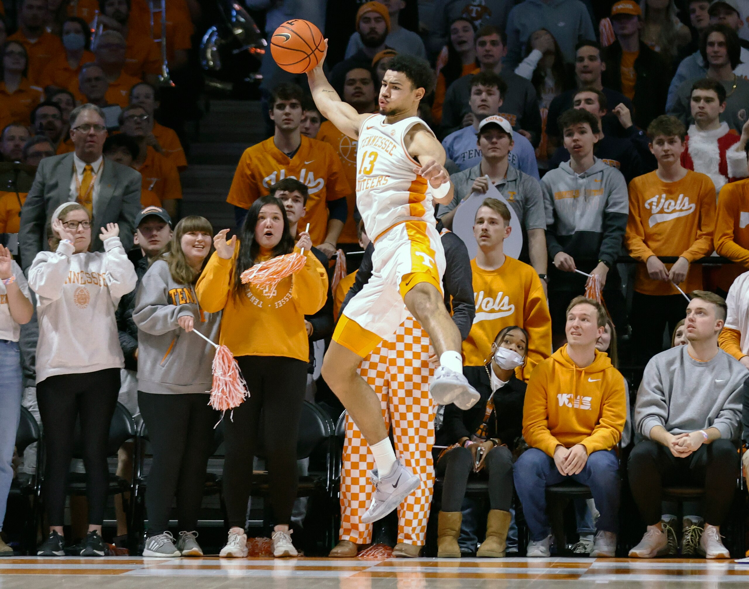Tennessee forward Olivier Nkamhoua (13) saves the ball from going out of bounds during an NCAA college basketball game against Arizona Wednesday, Dec. 22, 2021, in Knoxville, Tenn. (AP Photo/Wade Payne) Tennessee forward Olivier Nkamhoua (13) saves the ball from going out of bounds during an NCAA college basketball game against Arizona Wednesday, Dec. 22, 2021, in Knoxville, Tenn. (AP Photo/Wade Payne)