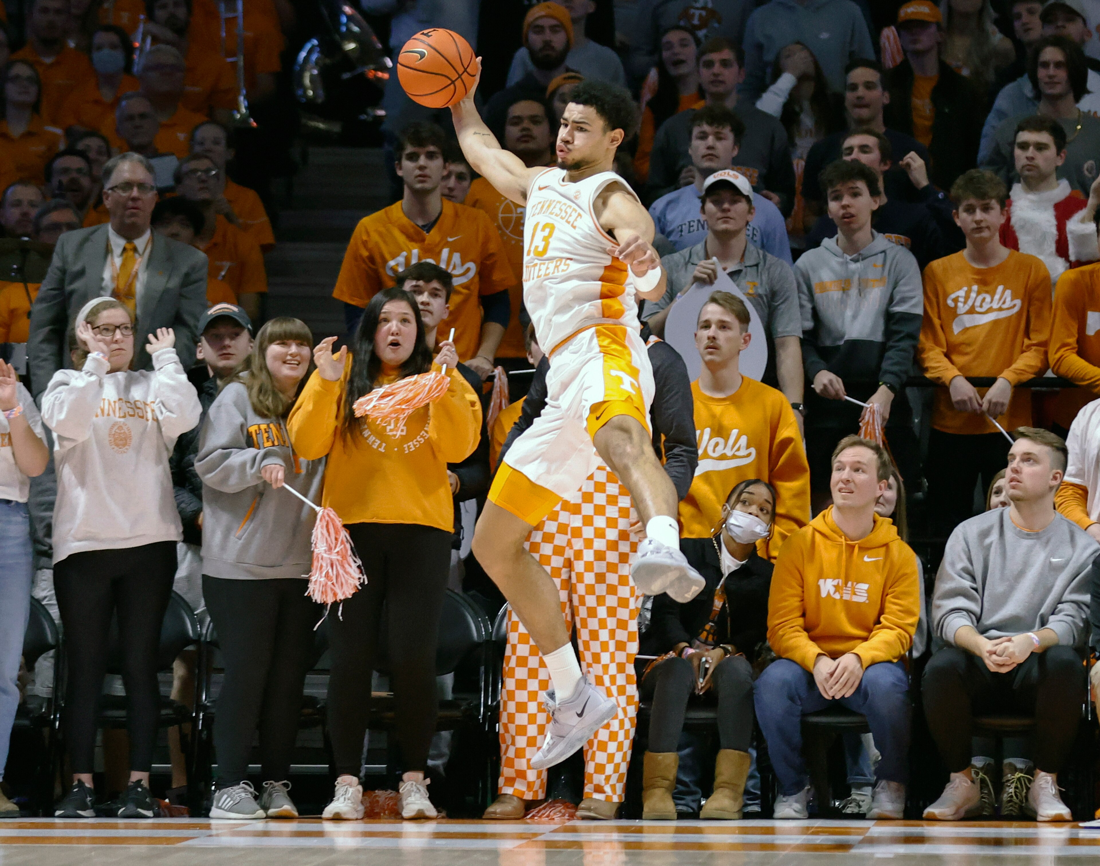 Tennessee forward Olivier Nkamhoua (13) saves the ball from going out of bounds during an NCAA college basketball game against Arizona Wednesday, Dec. 22, 2021, in Knoxville, Tenn. (AP Photo/Wade Payne)