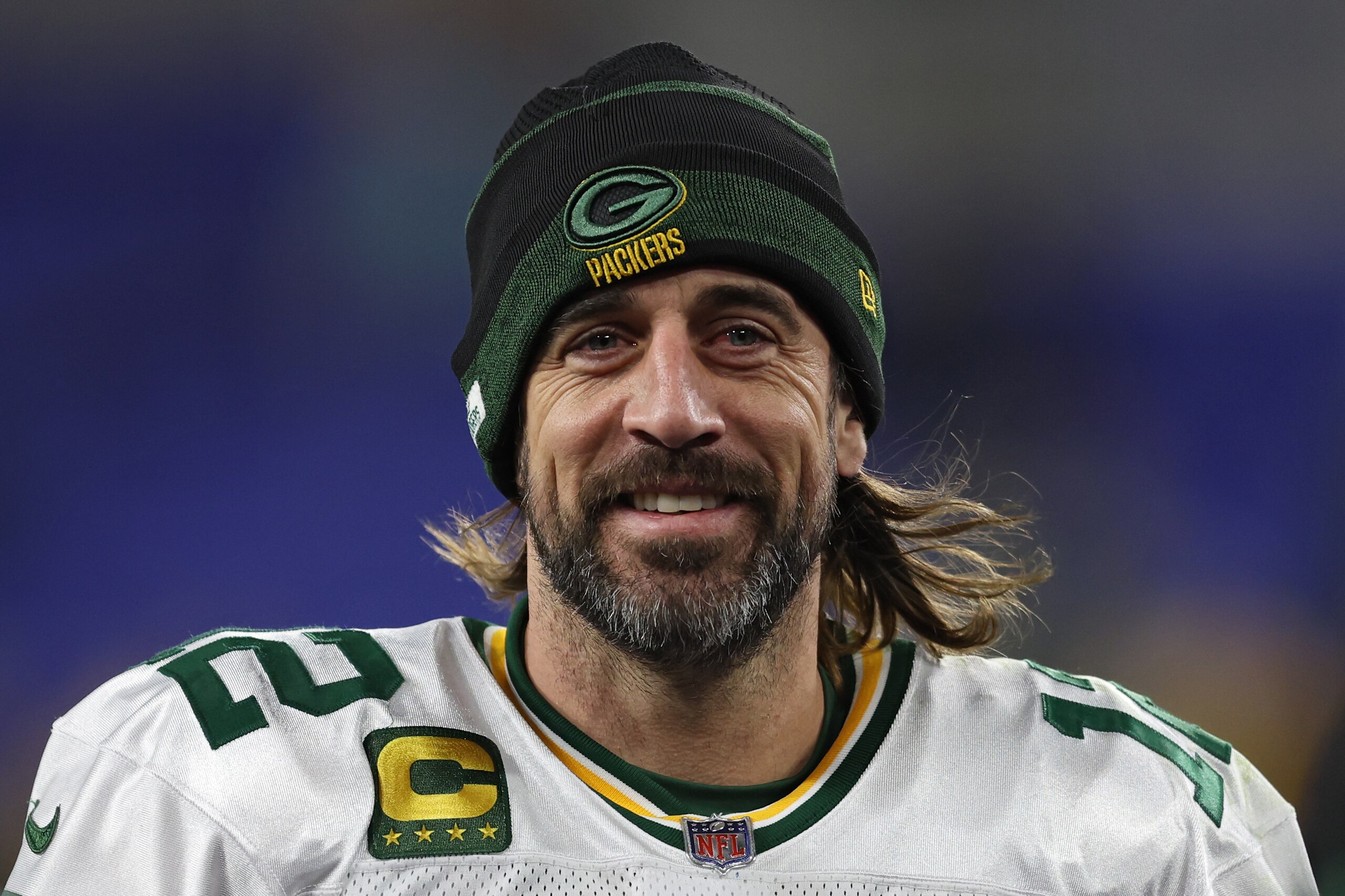 BALTIMORE, MARYLAND - DECEMBER 19: Aaron Rodgers #12 of the Green Bay Packers smiles as he walks off the field after their game against the Baltimore Ravens at M&T Bank Stadium on December 19, 2021 in Baltimore, Maryland. (Photo by Patrick Smith/Getty Images)