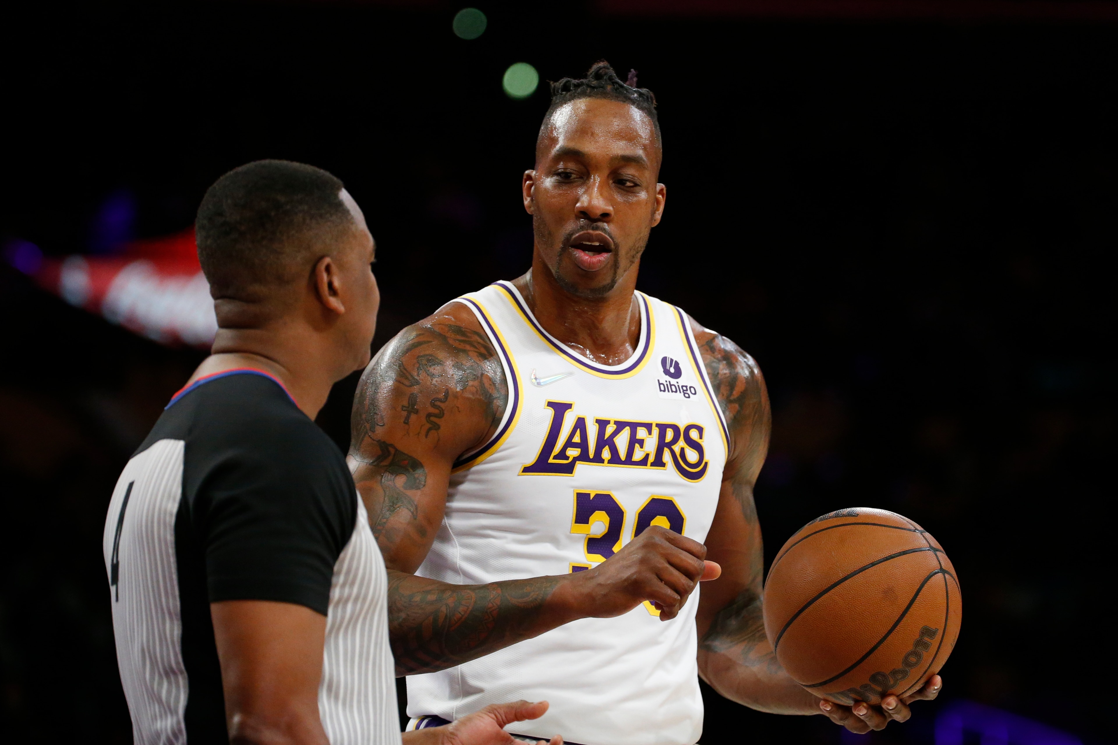 Los Angeles Lakers center Dwight Howard (39) confers with a referee during the first half of an NBA basketball game in Los Angeles, Sunday, Dec. 12, 2021. (AP Photo/Ringo H.W. Chiu)