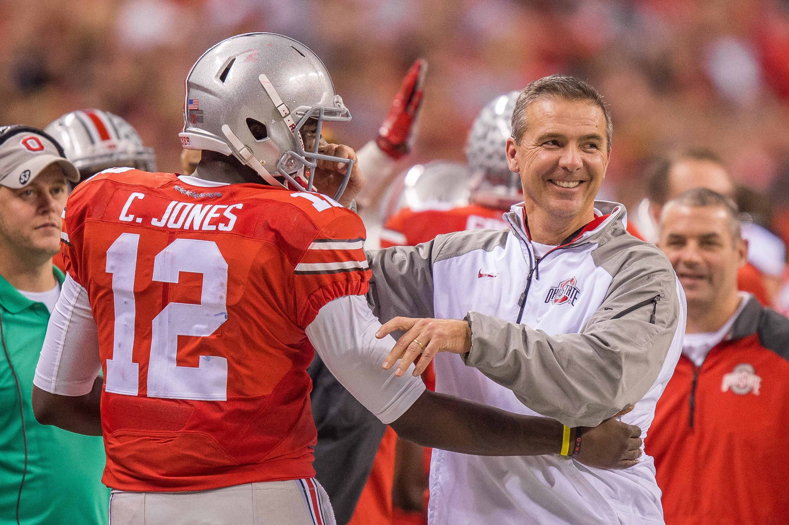 December 6, 2014: Ohio State Buckeyes head coach Urban Meyer greets Ohio State Buckeyes quarterback Cardale Jones (12) after he leaves the field in the fourth quarter during the NCAA Big 10 Championship football game between the Wisconsin Badgers and Ohio State Buckeyes at Lucas Oil Stadium in Indianapolis, IN. (Photo by Zach Bolinger/Icon Sportswire/Corbis/Icon Sportswire via Getty Images) December 6, 2014: Ohio State Buckeyes head coach Urban Meyer greets Ohio State Buckeyes quarterback Cardale Jones (12) after he leaves the field in the fourth quarter during the NCAA Big 10 Championship football game between the Wisconsin Badgers and Ohio State Buckeyes at Lucas Oil Stadium in Indianapolis, IN. (Photo by Zach Bolinger/Icon Sportswire/Corbis/Icon Sportswire via Getty Images)