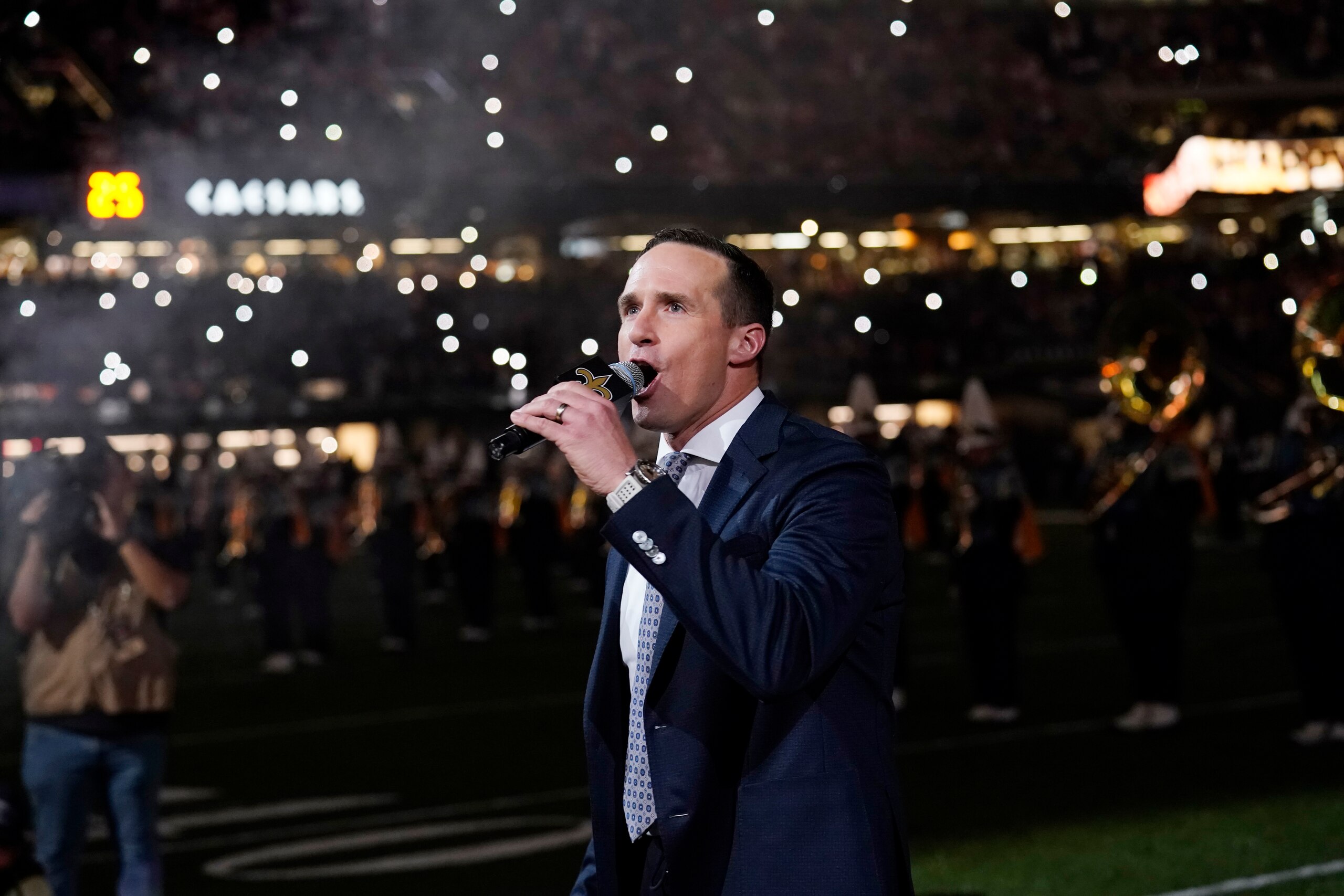 Former New Orleans Saints quarterback Drew Brees leads a crowd cheer as he is honored during a ceremony at halftime of an NFL football game between the New Orleans Saints and the Buffalo Bills in New Orleans, Thursday, Nov. 25, 2021. (AP Photo/Derick Hingle)