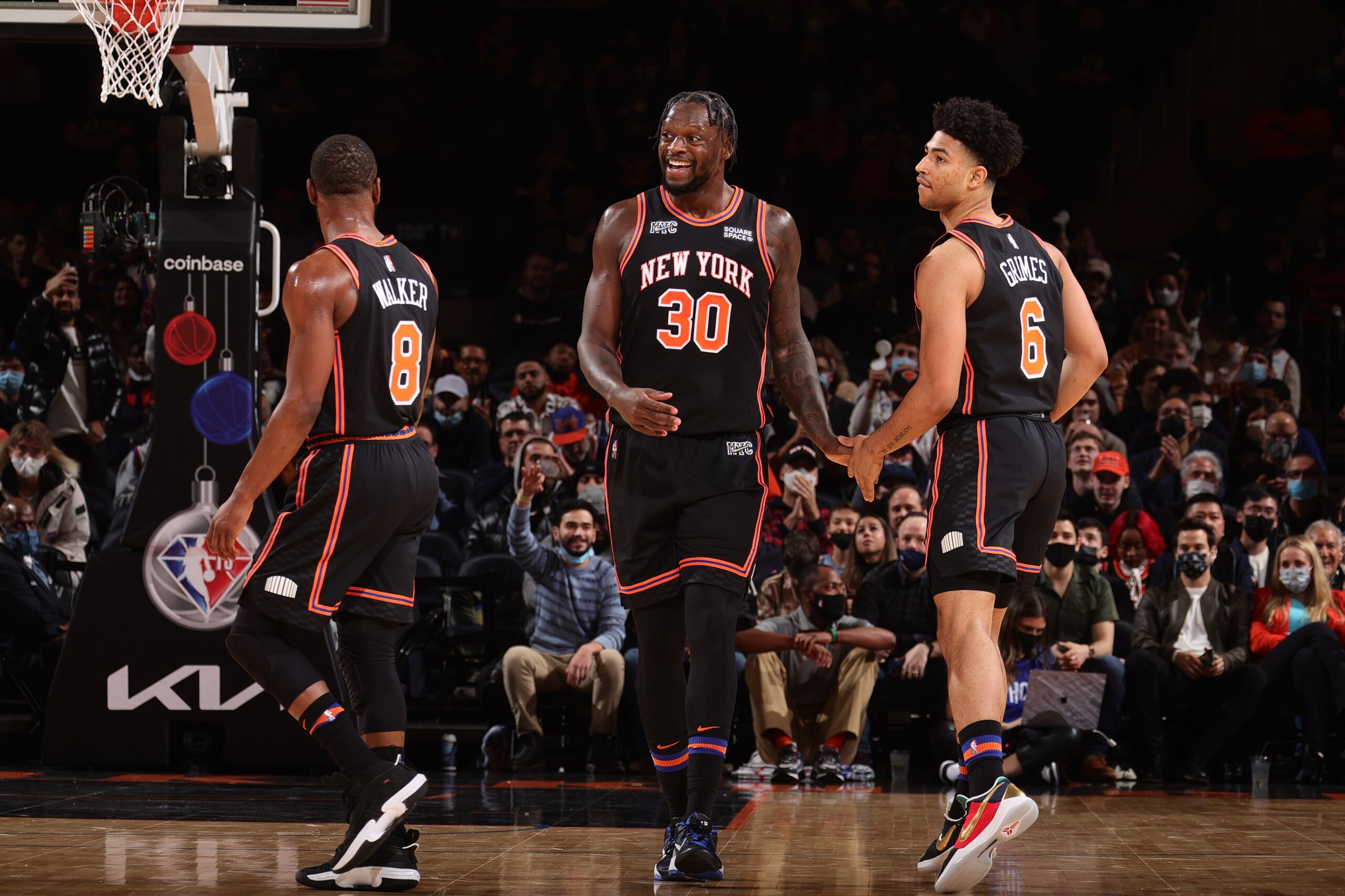 NEW YORK, NY - DECEMBER 25: Julius Randle #30 hi-fives Quentin Grimes #6 and Kemba Walker #8 of the New York Knicks during the game against the Atlanta Hawks on December 25, 2021 at Madison Square Garden in New York City, New York.  NOTE TO USER: User expressly acknowledges and agrees that, by downloading and or using this photograph, User is consenting to the terms and conditions of the Getty Images License Agreement. Mandatory Copyright Notice: Copyright 2021 NBAE  (Photo by Nathaniel S. Butler/NBAE via Getty Images)