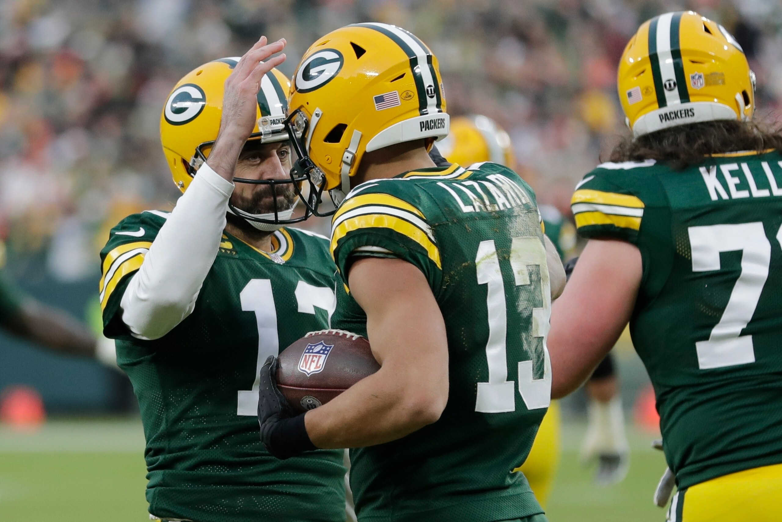 Green Bay Packers' Aaron Rodgers is congratulated by Allen Lazard after throwing career touchdown pass 443 during the first half of an NFL football game against the Cleveland Browns Saturday, Dec. 25, 2021, in Green Bay, Wis. The pass breaks the previous Green Bay Packers record held by Brett Favre. (AP Photo/Aaron Gash)