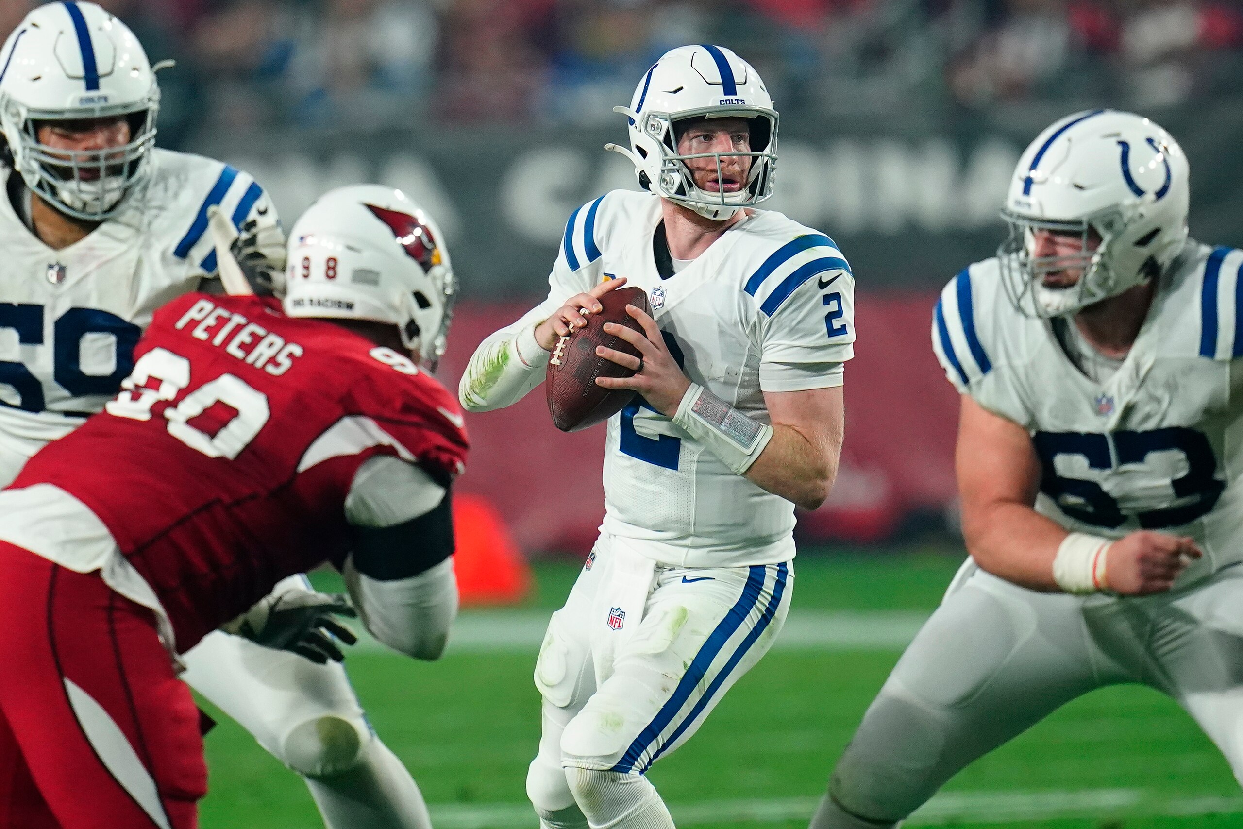 Indianapolis Colts quarterback Carson Wentz (2) looks to pass against the Arizona Cardinals during the first half of an NFL football game, Saturday, Dec. 25, 2021, in Glendale, Ariz. (AP Photo/Ross D. Franklin)