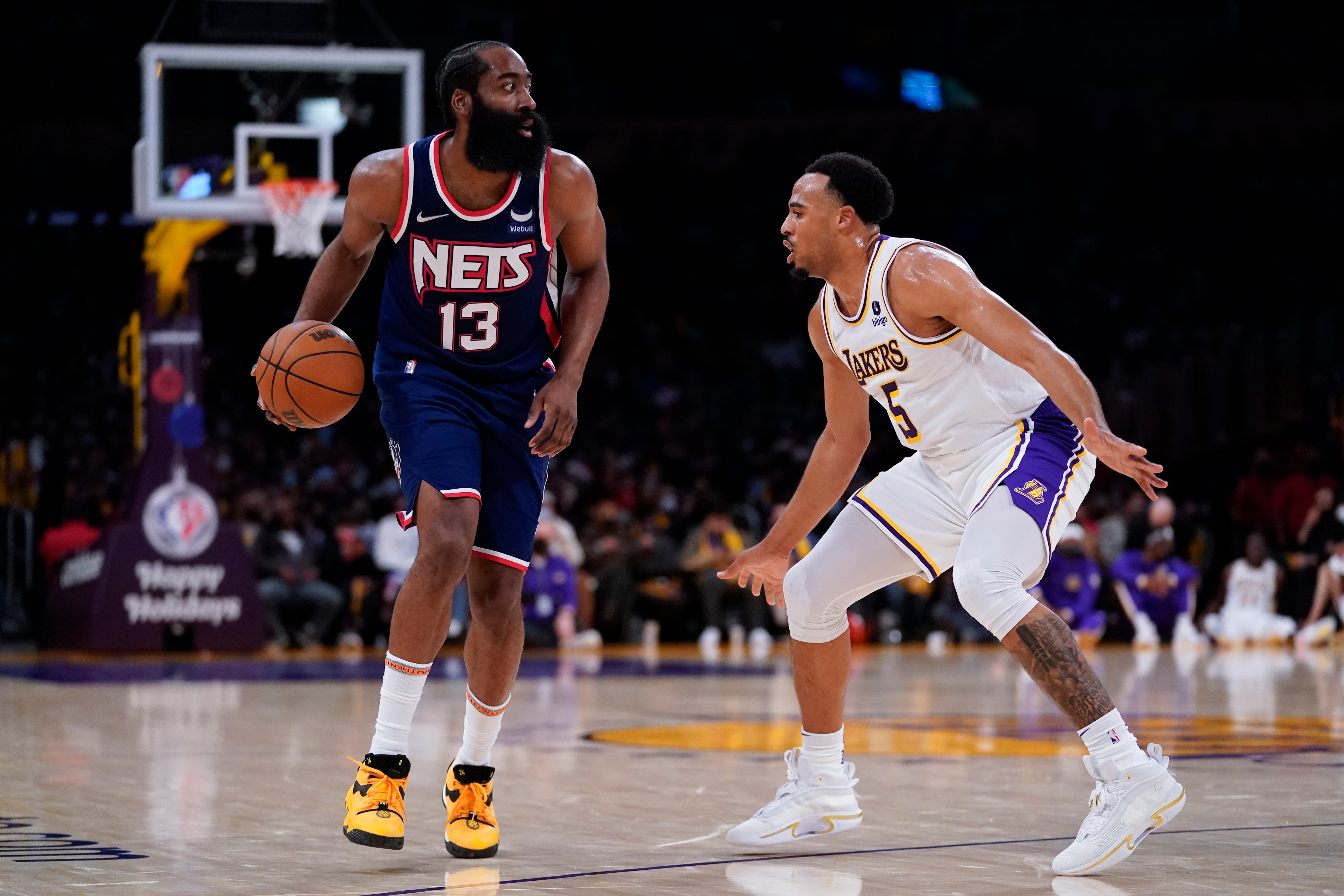 Los Angeles Lakers guard Talen Horton-Tucker (5) defends against Brooklyn Nets guard James Harden (13) during the first half of an NBA basketball game in Los Angeles, Saturday, Dec. 25, 2021. (AP Photo/Ashley Landis)
