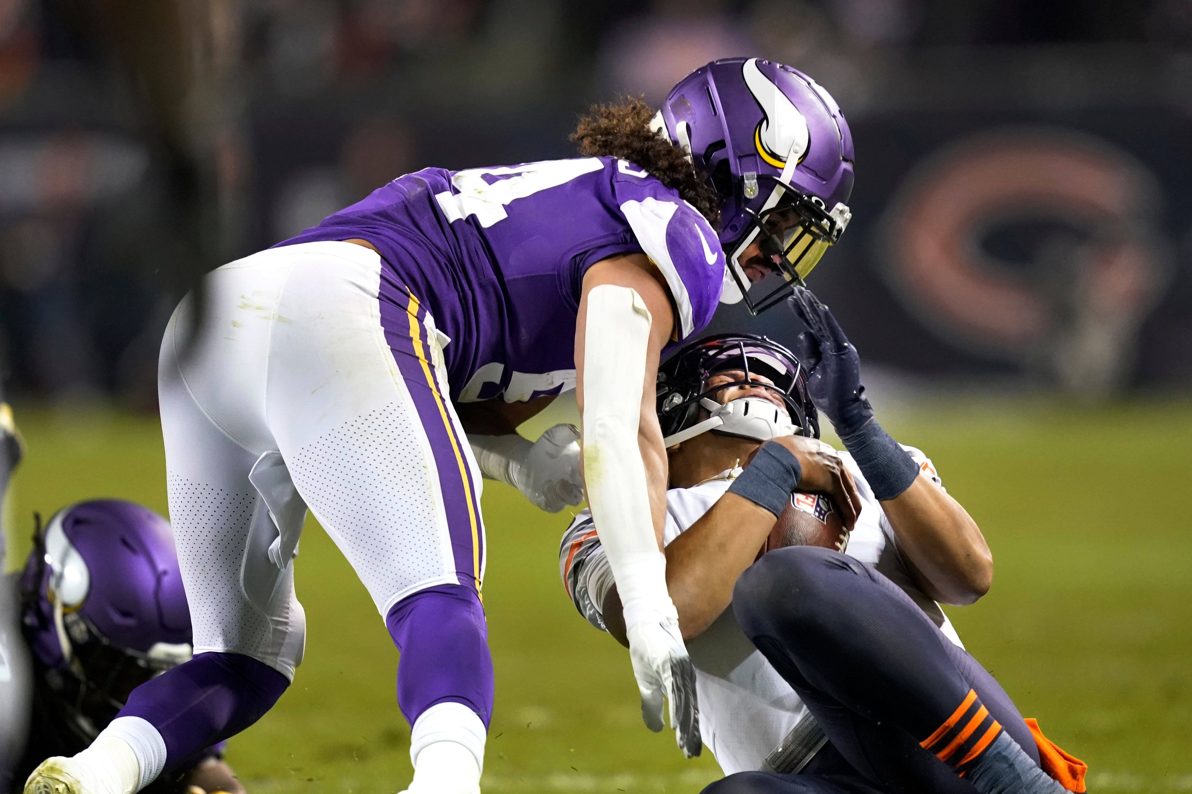Minnesota Vikings middle linebacker Eric Kendricks hits Chicago Bears quarterback Justin Fields after Fields gave himself up during the second half of an NFL football game Monday, Dec. 20, 2021, in Chicago. Eric Kendricks was ejected from the game. (AP Photo/David Banks)
