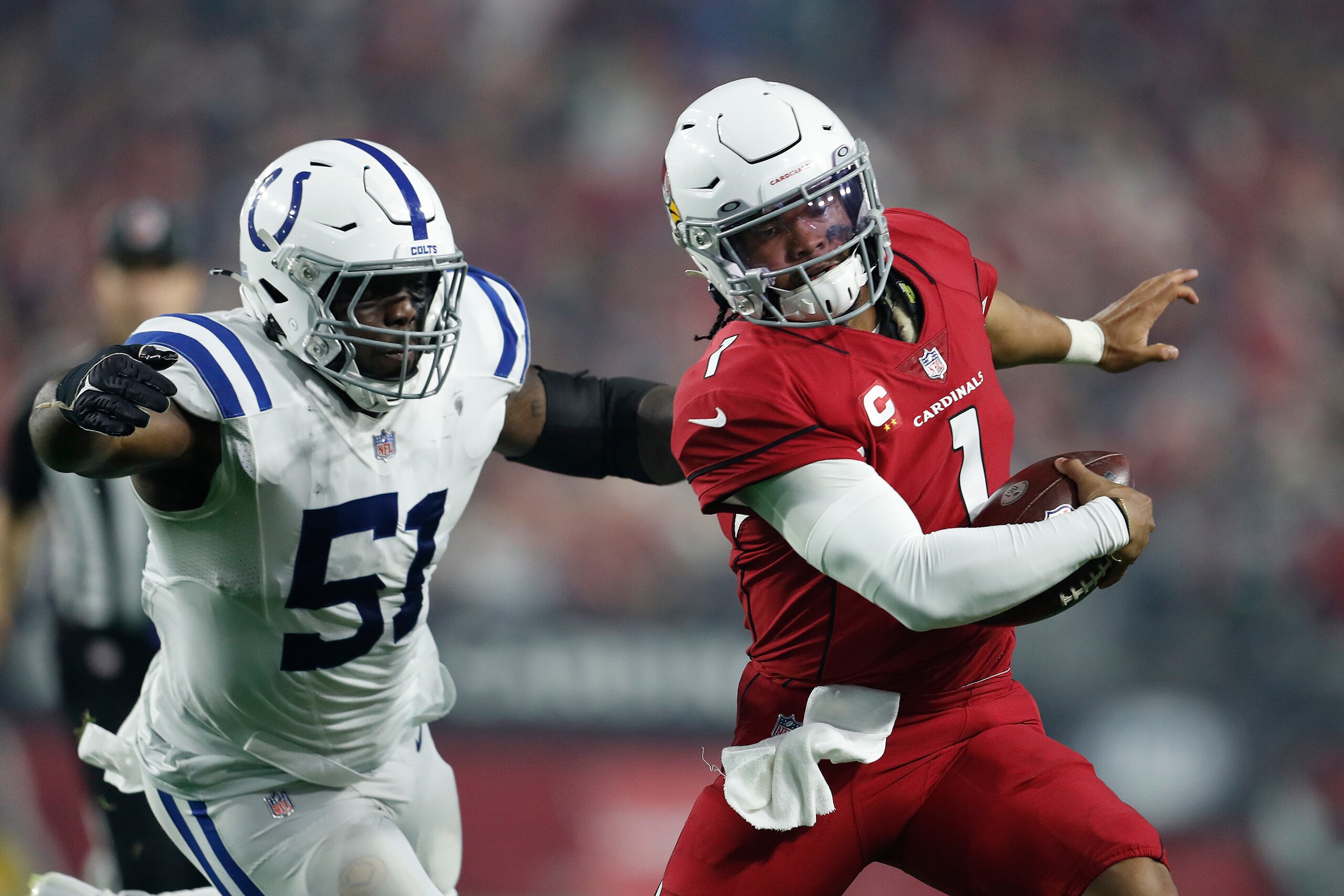 GLENDALE, ARIZONA - DECEMBER 25: Kyler Murray #1 of the Arizona Cardinals scrambles away from Kwity Paye #51 of the Indianapolis Colts during the third quarter at State Farm Stadium on December 25, 2021 in Glendale, Arizona. (Photo by Chris Coduto/Getty Images)